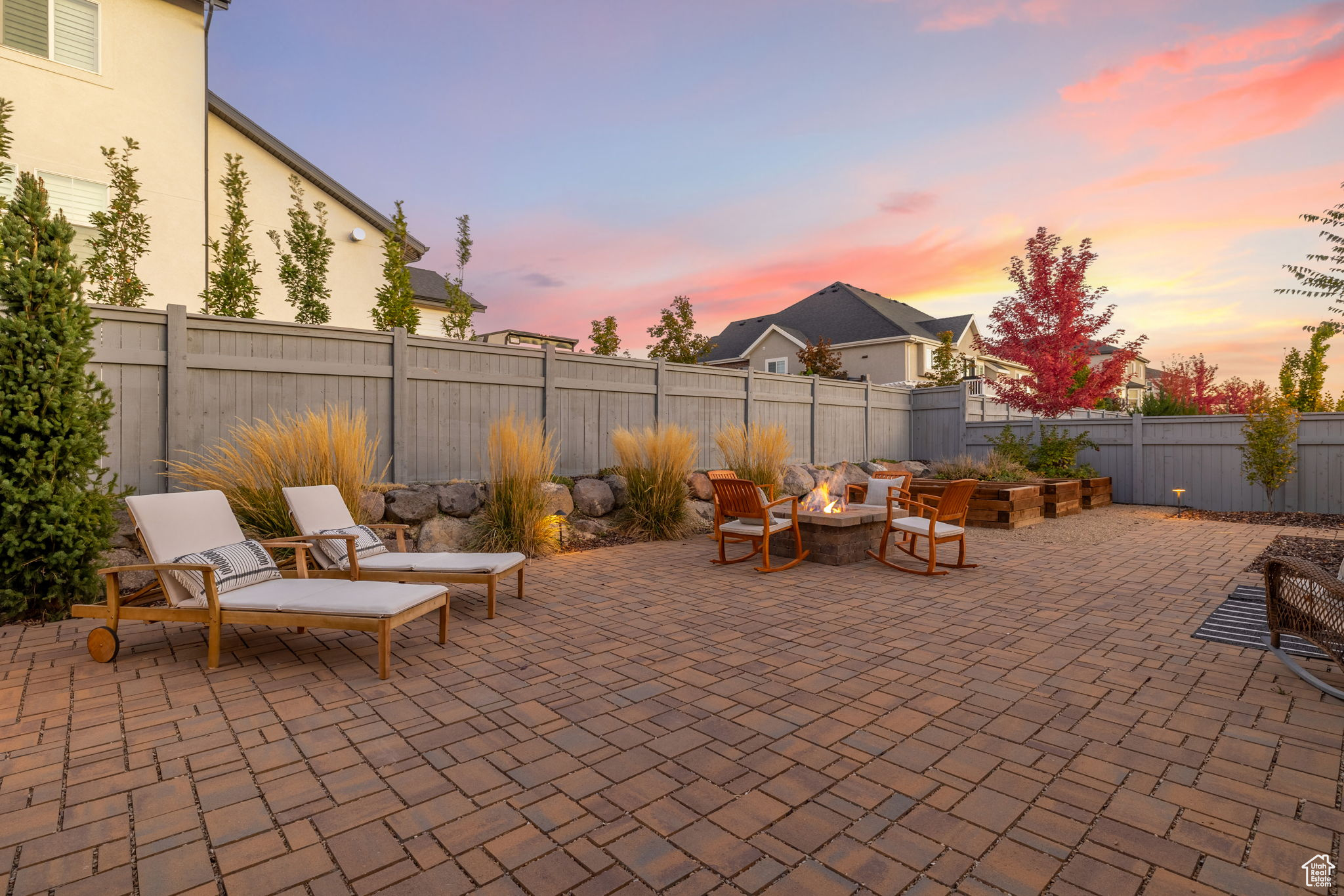 Patio terrace at dusk featuring an outdoor fire pit