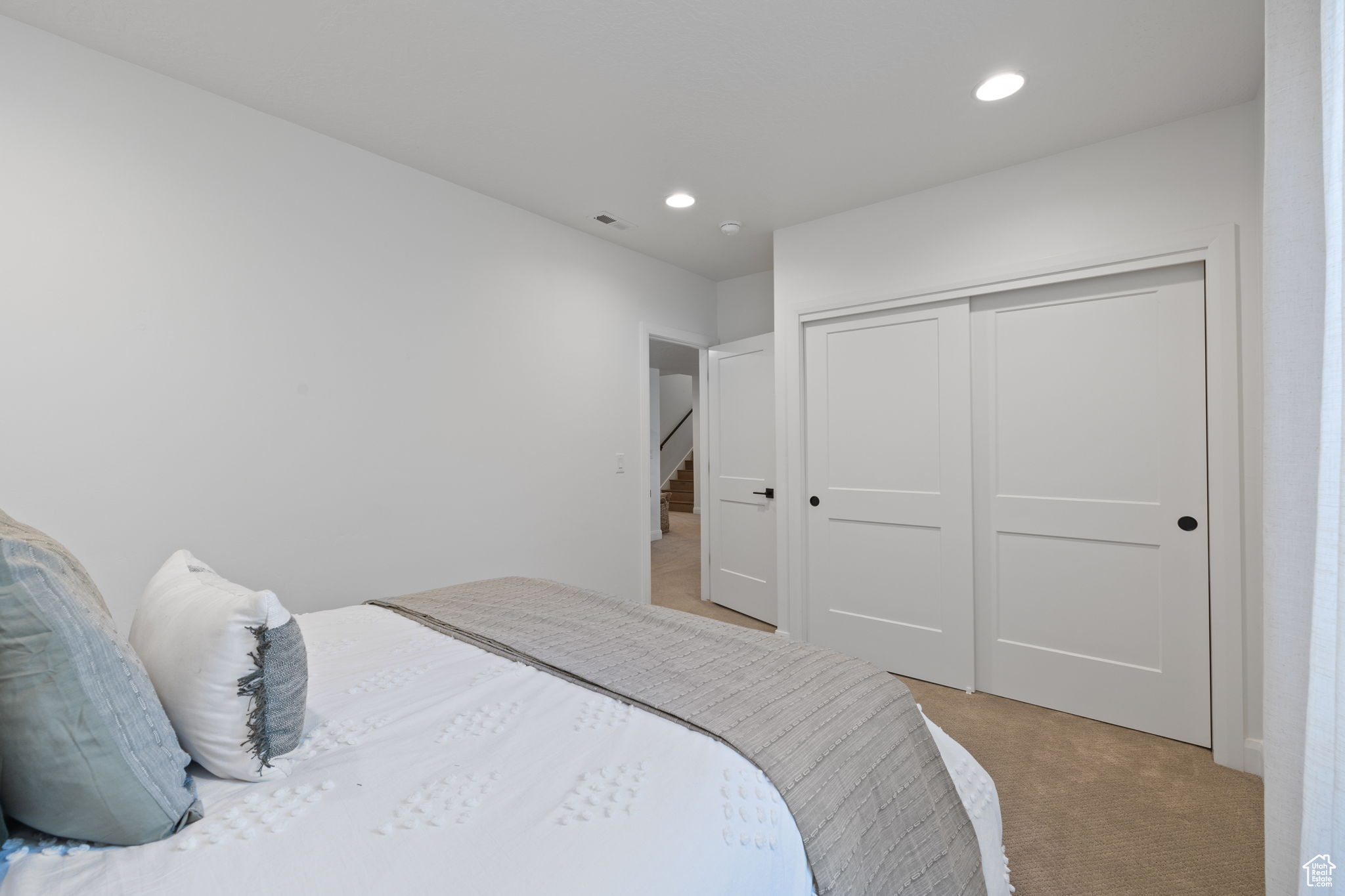 Carpeted bedroom with a closet