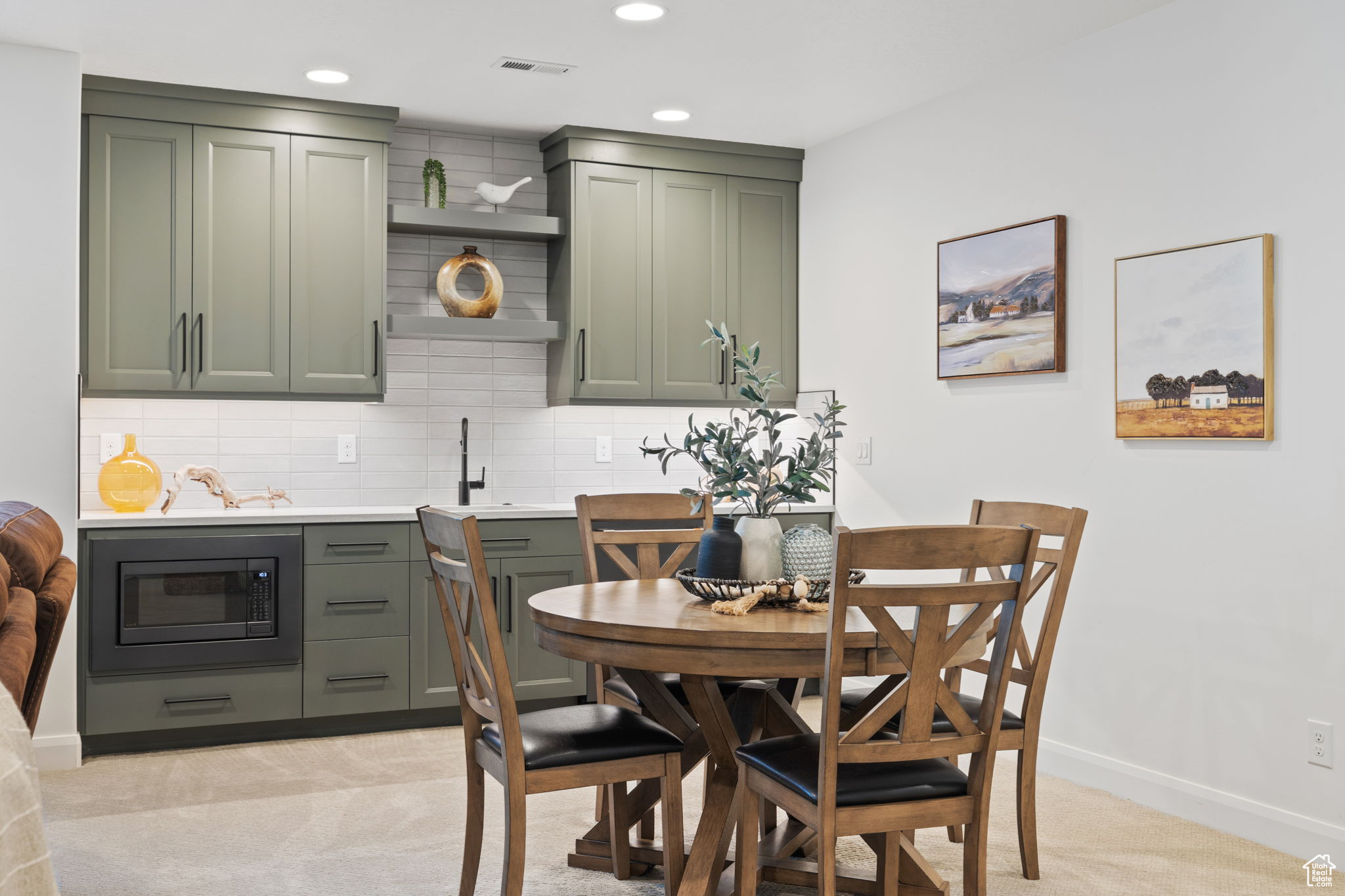 Dining space featuring light carpet and sink