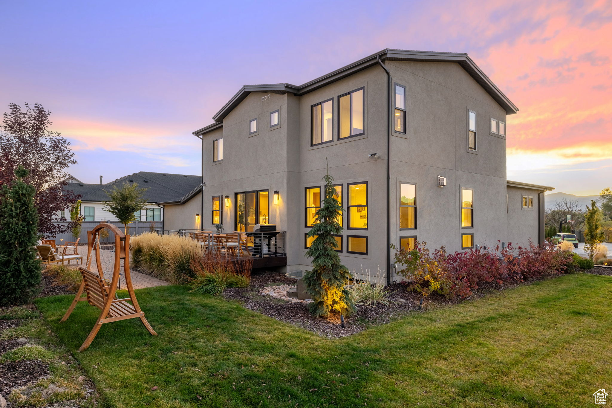 Back house at dusk with a yard