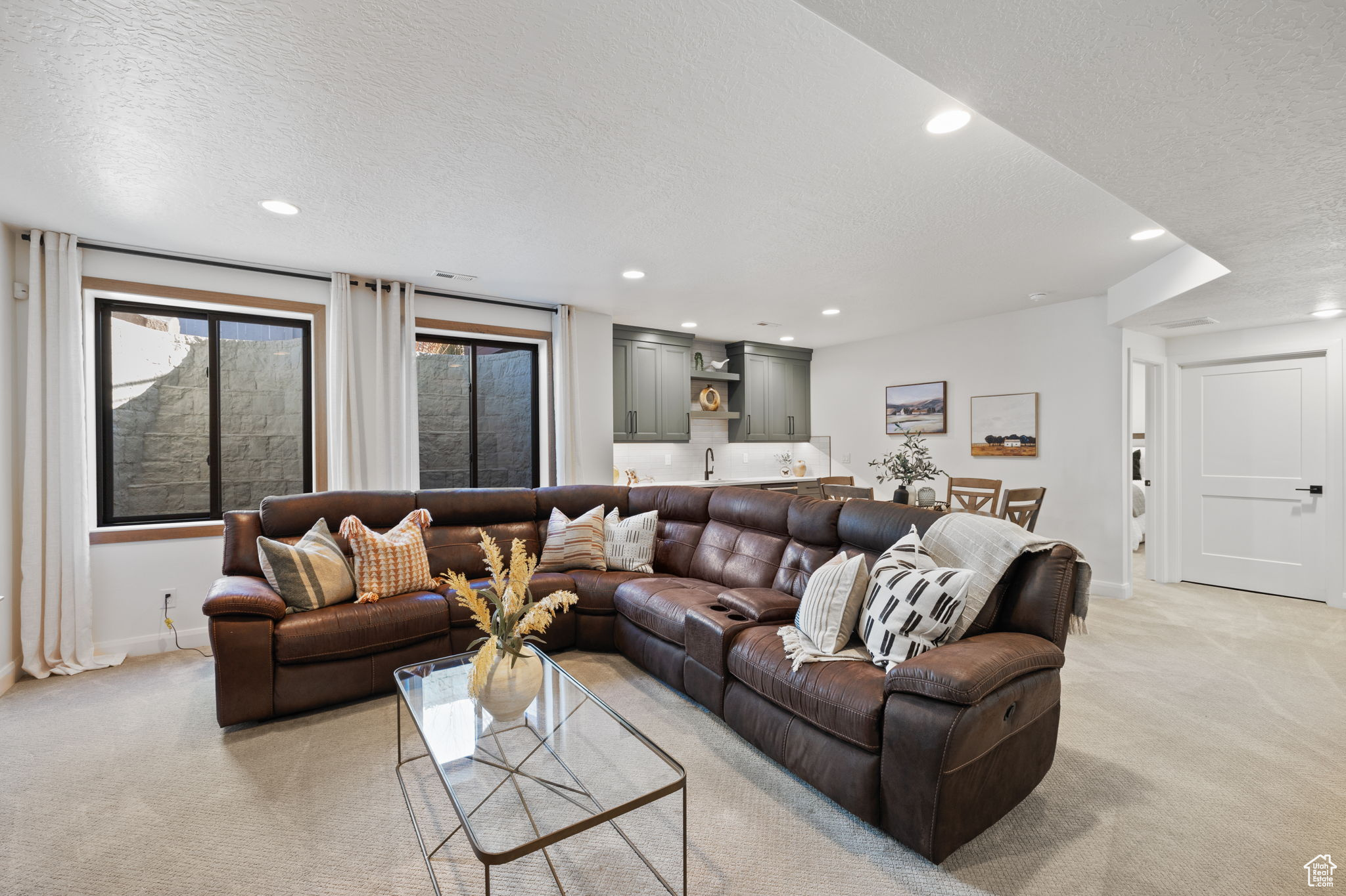 Carpeted living room featuring a textured ceiling