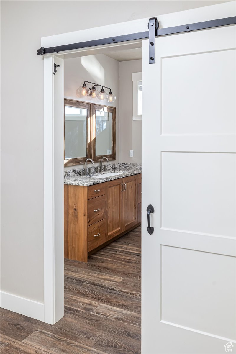 Bathroom with hardwood / wood-style floors and vanity