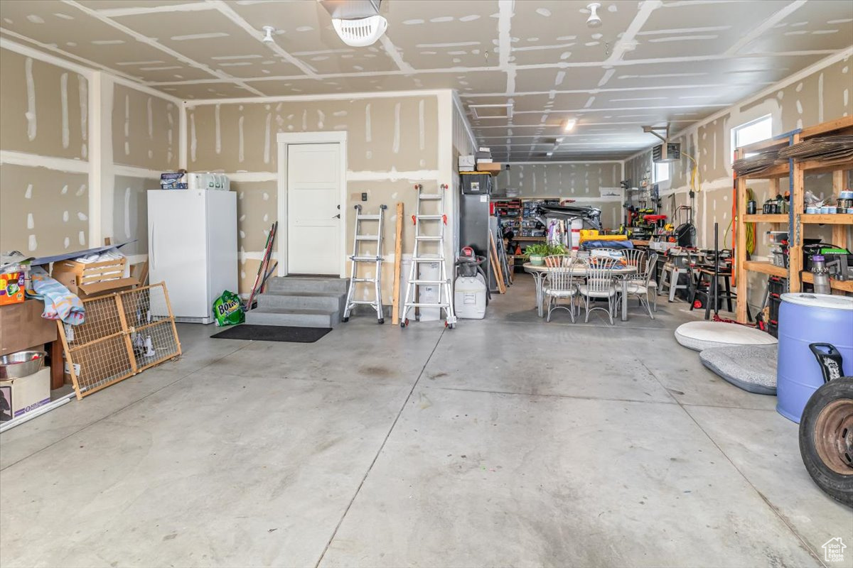 Garage with white refrigerator