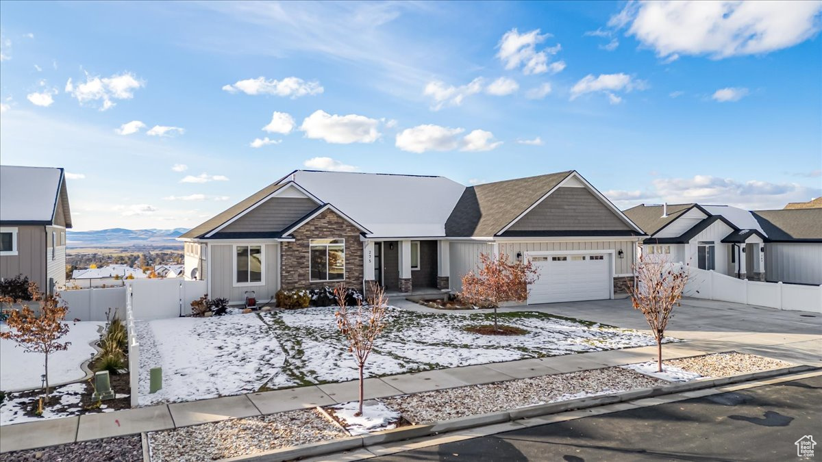 View of front of property with a mountain view and a garage