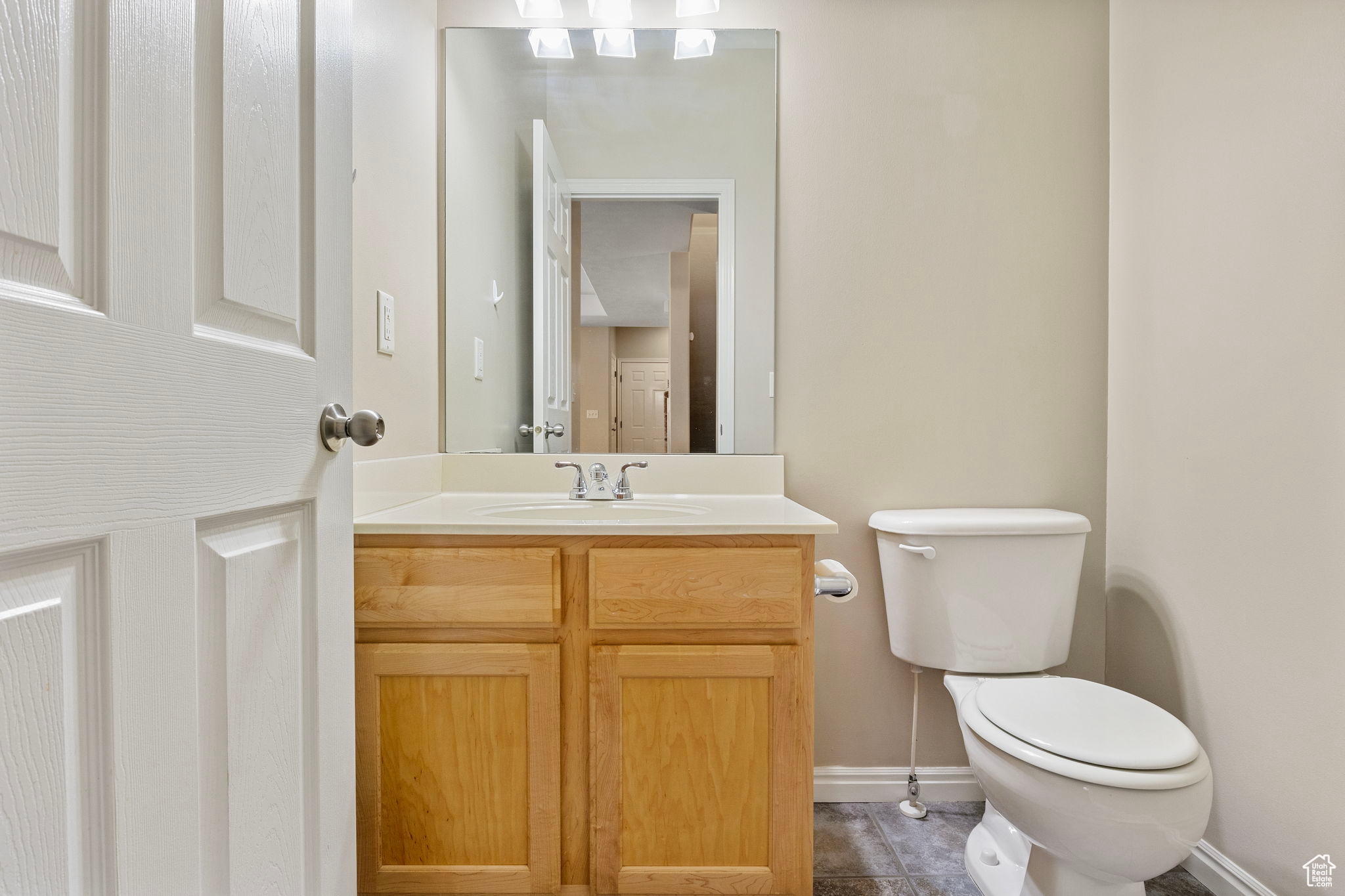 Bathroom with tile patterned floors, vanity, and toilet