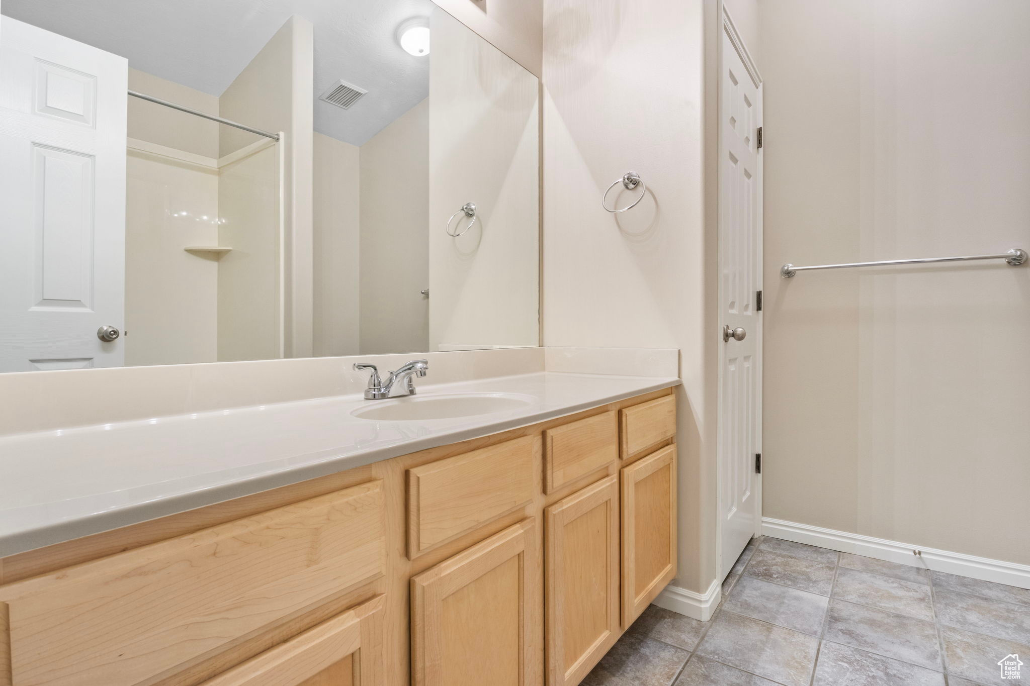 Bathroom featuring tile patterned floors and vanity