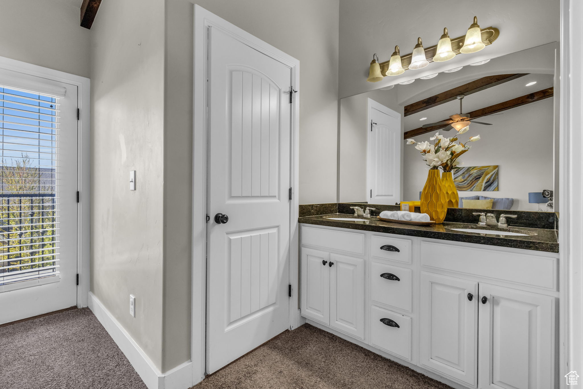 Bathroom featuring beam ceiling, vanity, a wealth of natural light, and ceiling fan