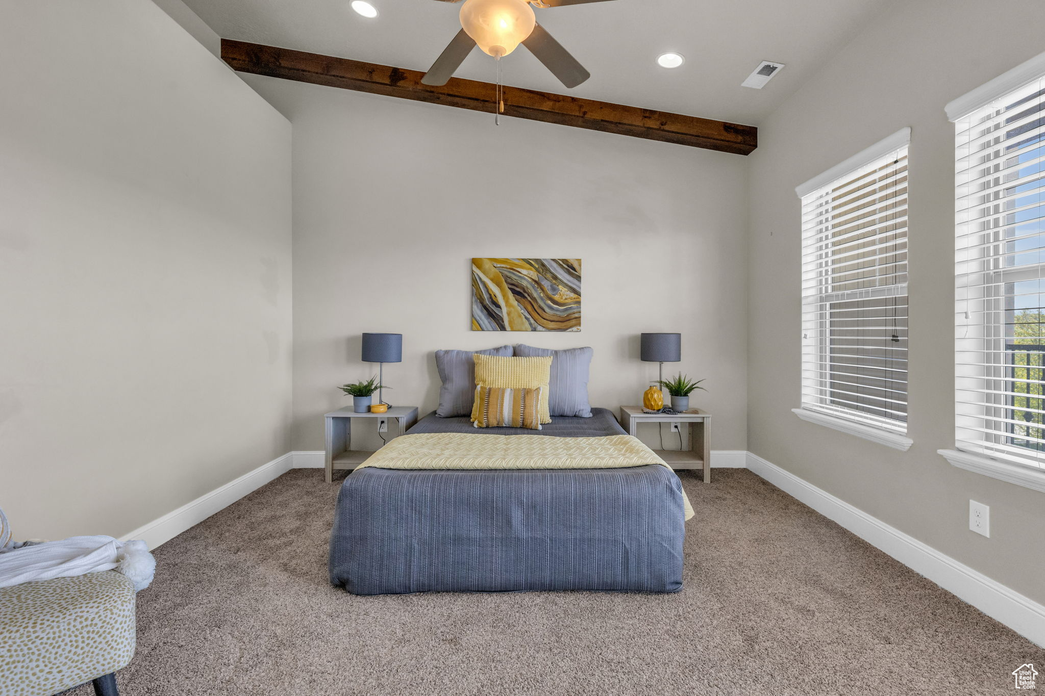 Carpeted bedroom with ceiling fan and lofted ceiling with beams