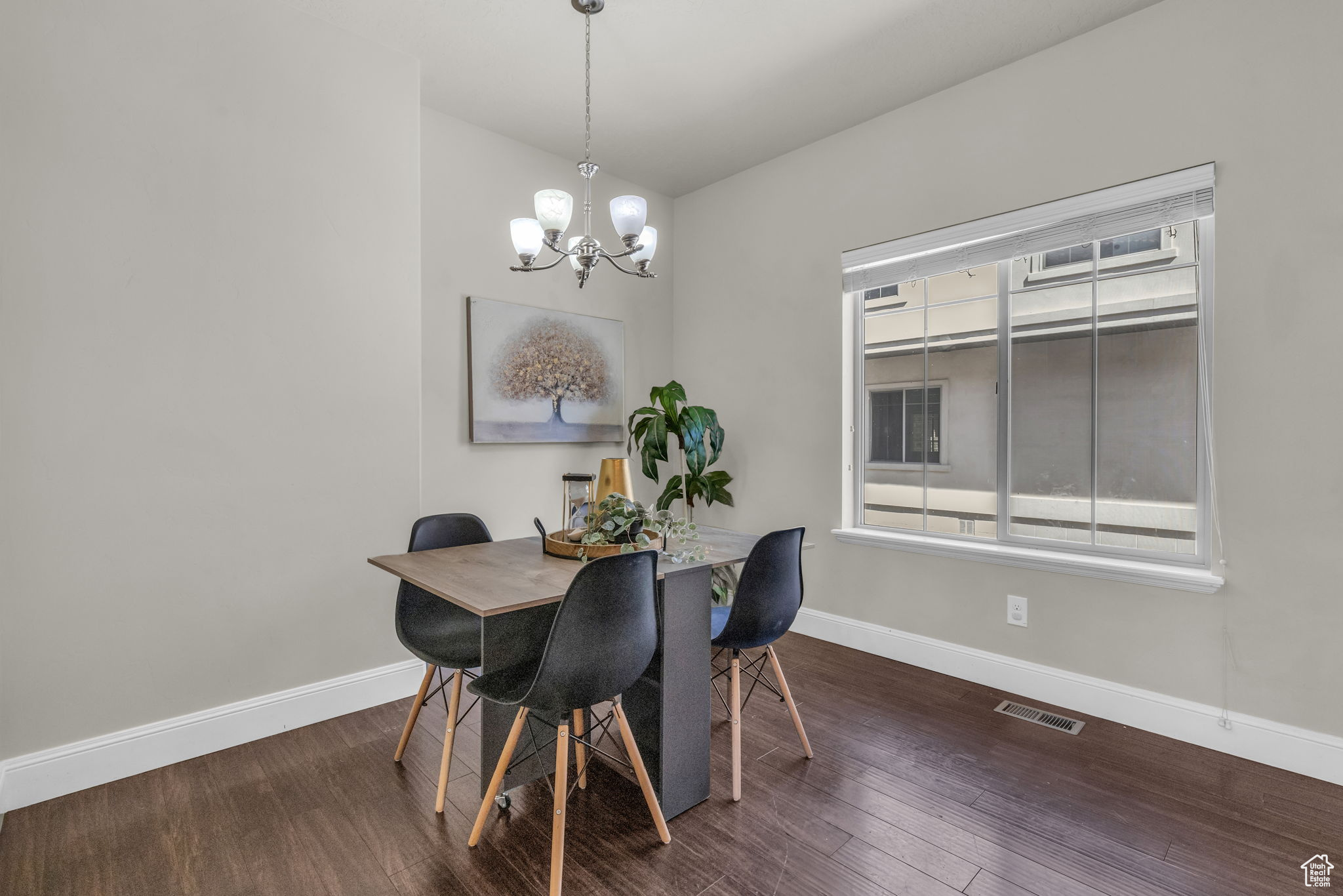 Dining room featuring dark wood-type flooring and an inviting chandelier