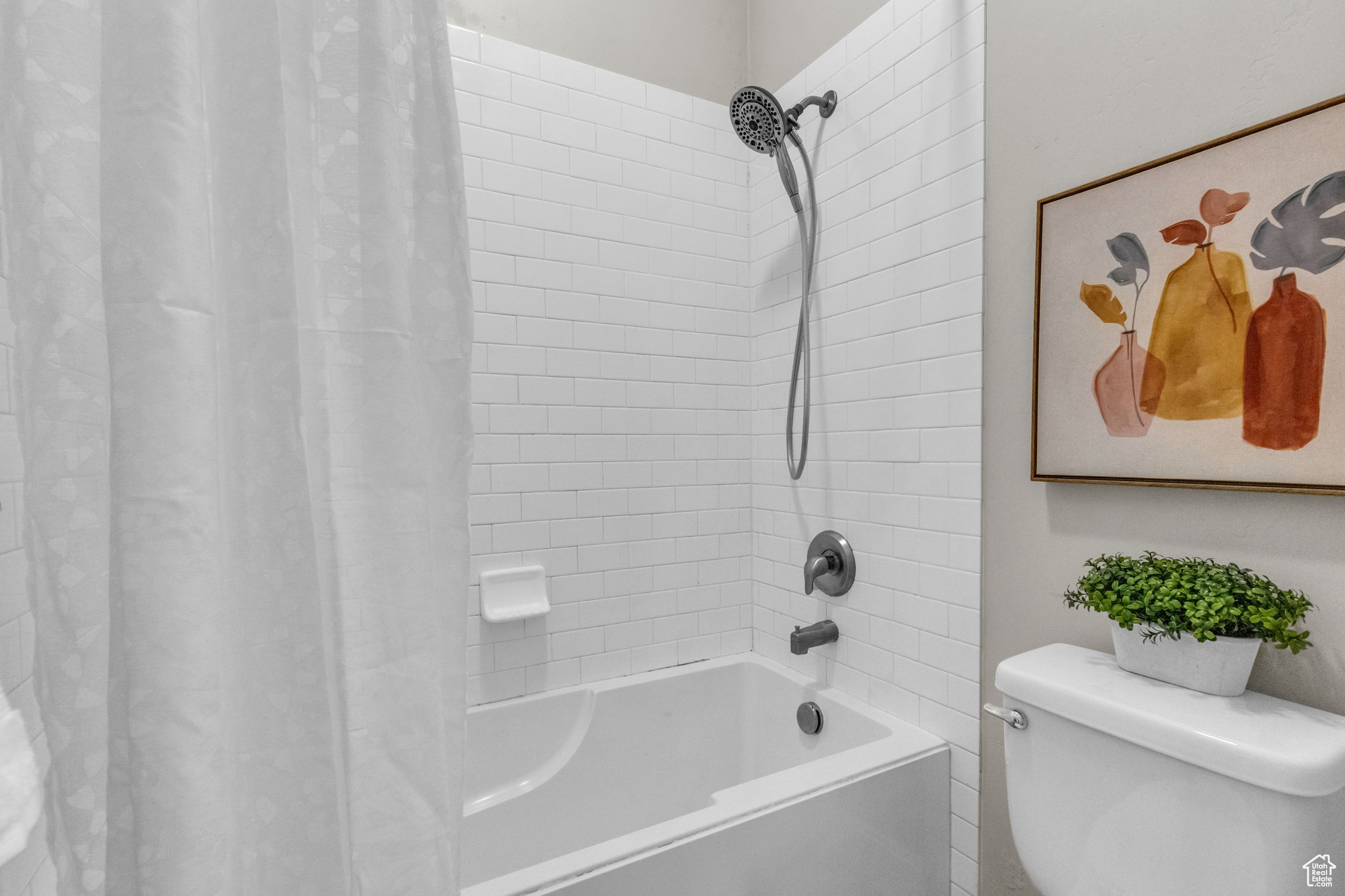 Bathroom with shower / bath combo with shower curtain and toilet