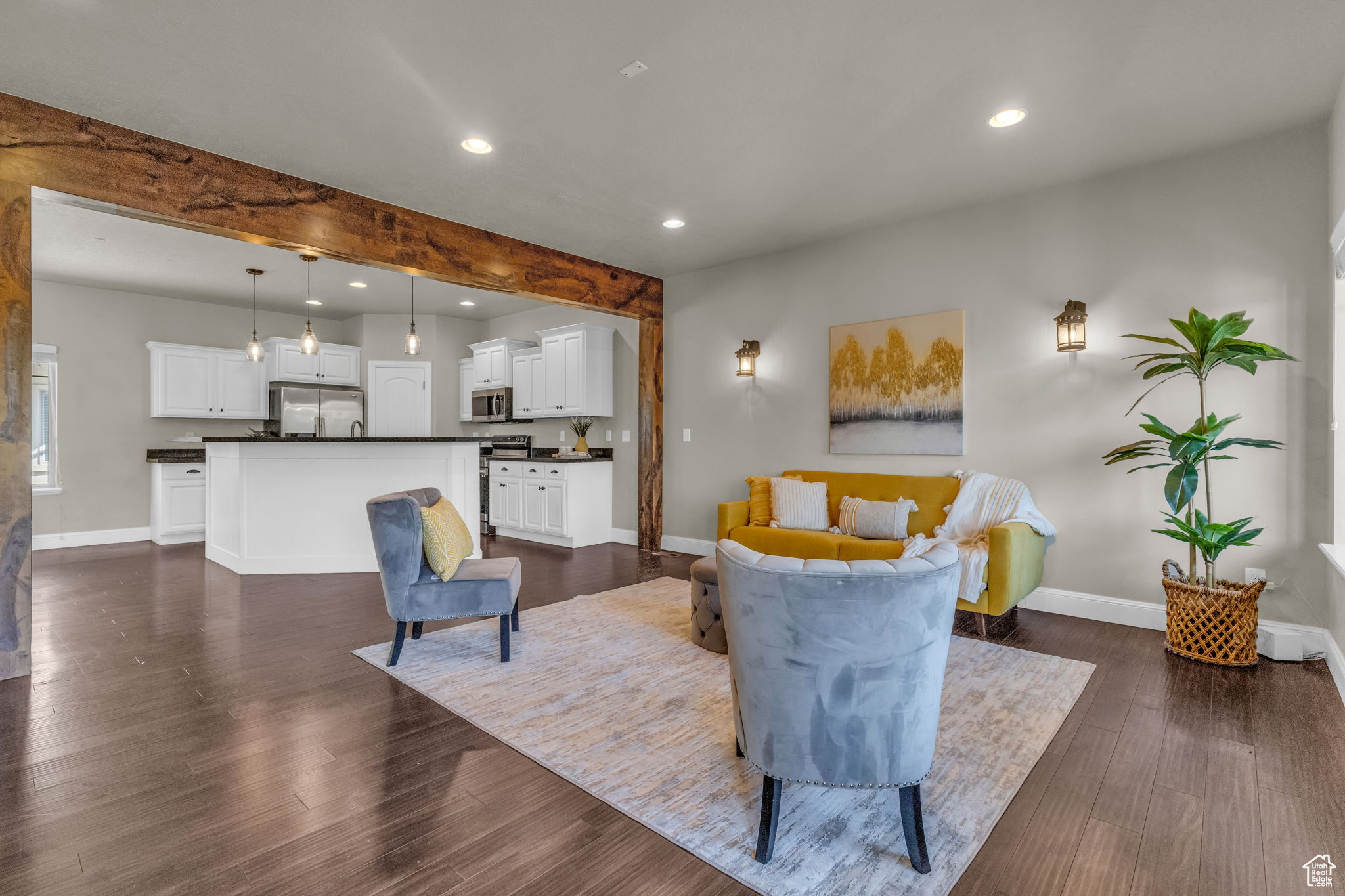 Living room with beam ceiling and dark hardwood / wood-style flooring