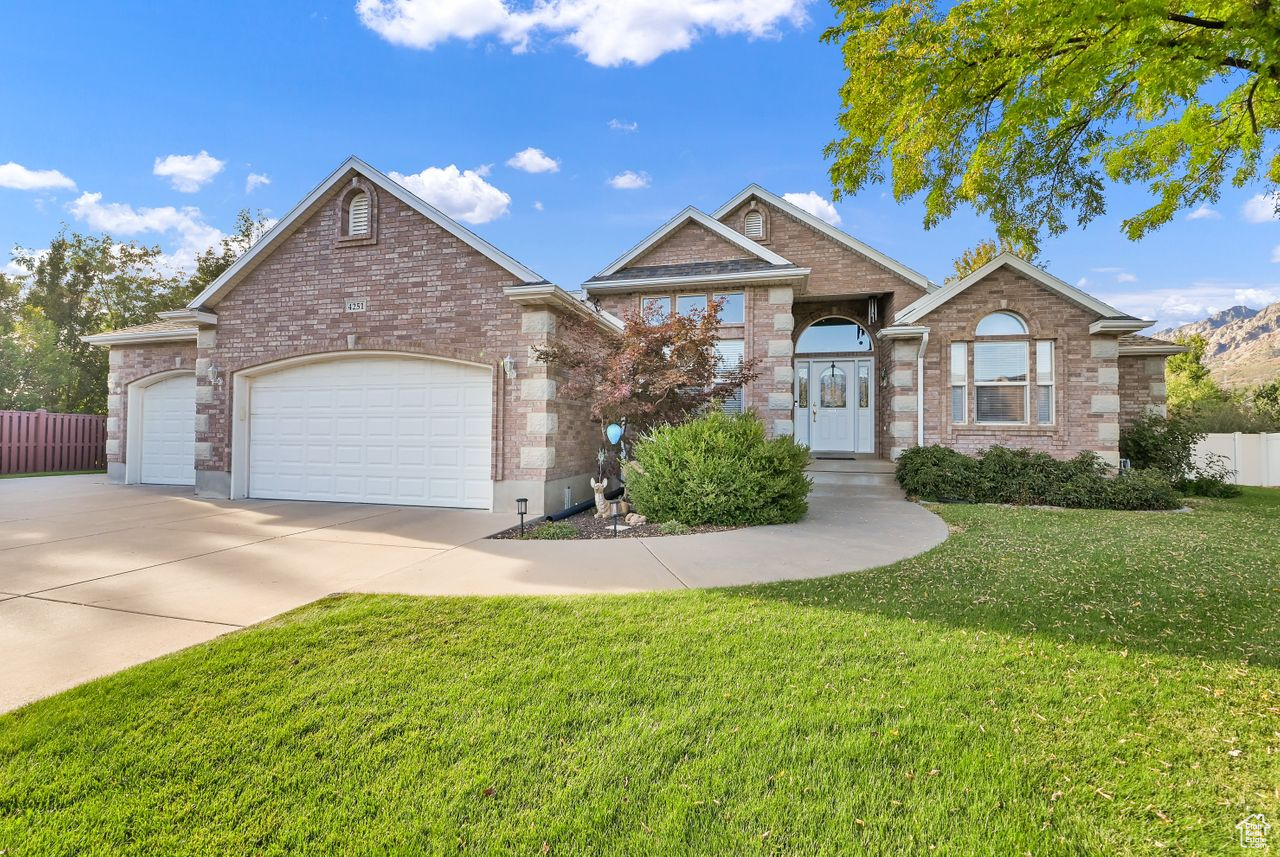 View of front of home with a garage and a front yard