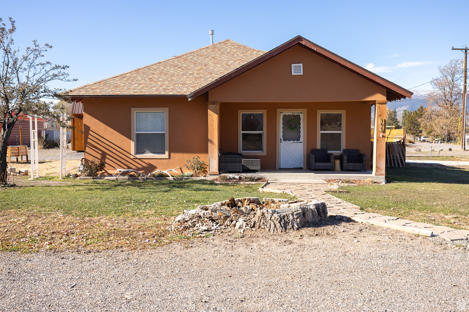 Bungalow-style home featuring a front yard and covered porch