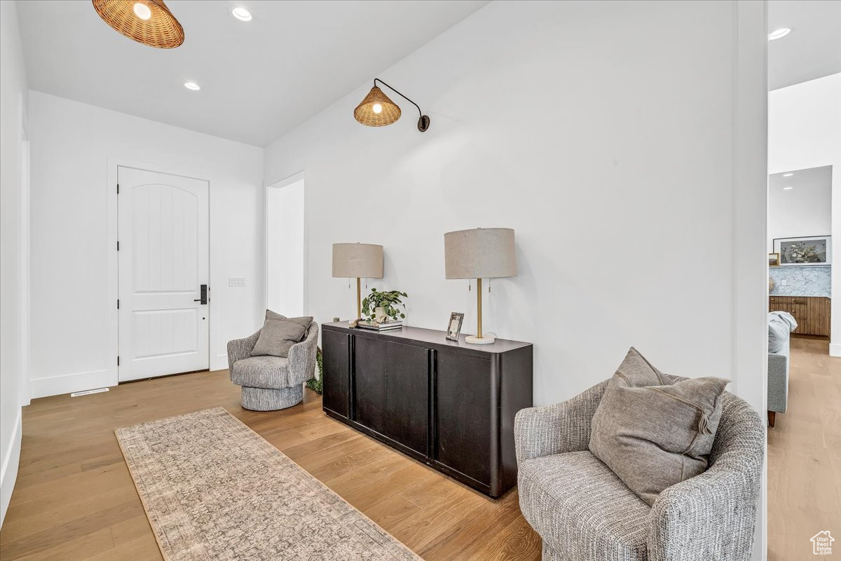 Sitting room with light hardwood / wood-style flooring