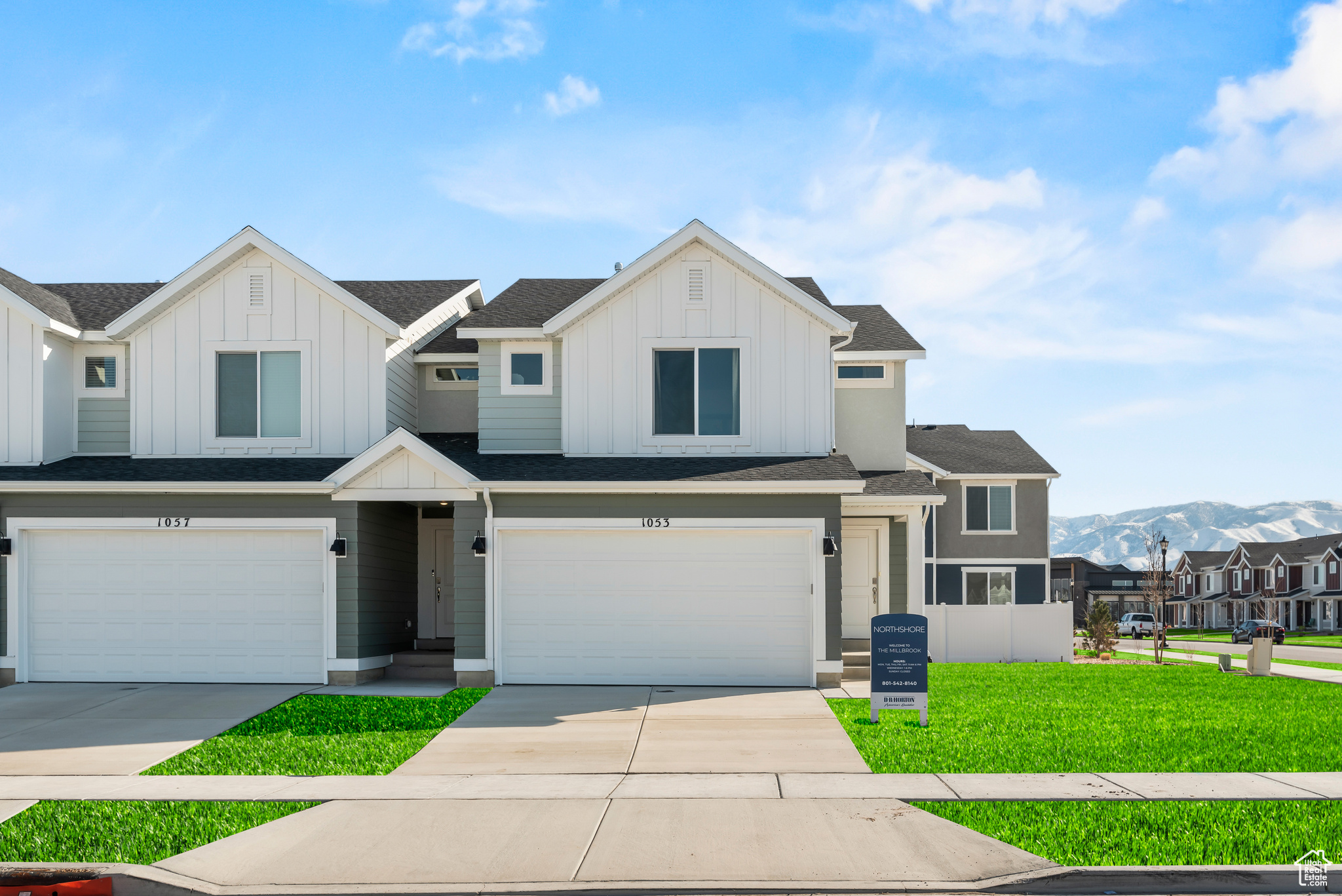 View of front of house featuring a mountain view, a garage, and a front yard