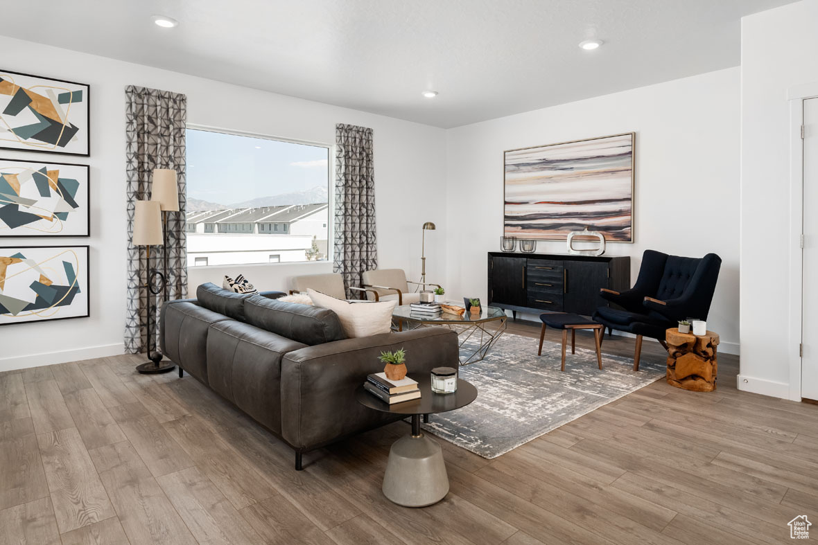 Living room with light hardwood / wood-style floors