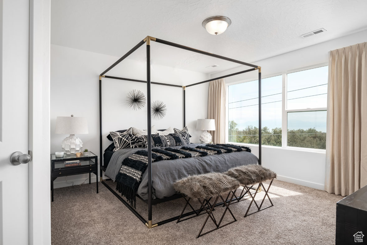 Bedroom with carpet flooring and a textured ceiling