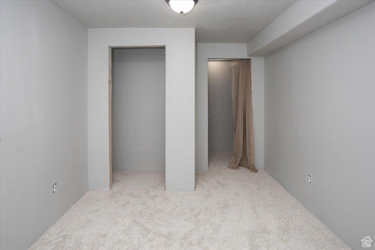 Bedroom with light carpet