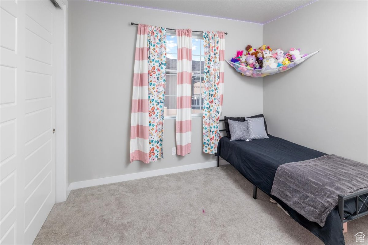 Bedroom with light colored carpet