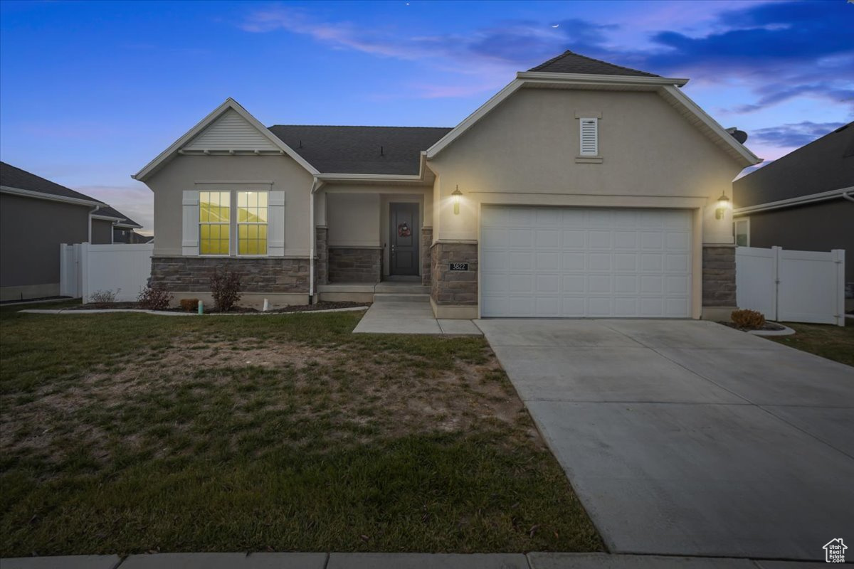 View of front of house with a lawn and a garage