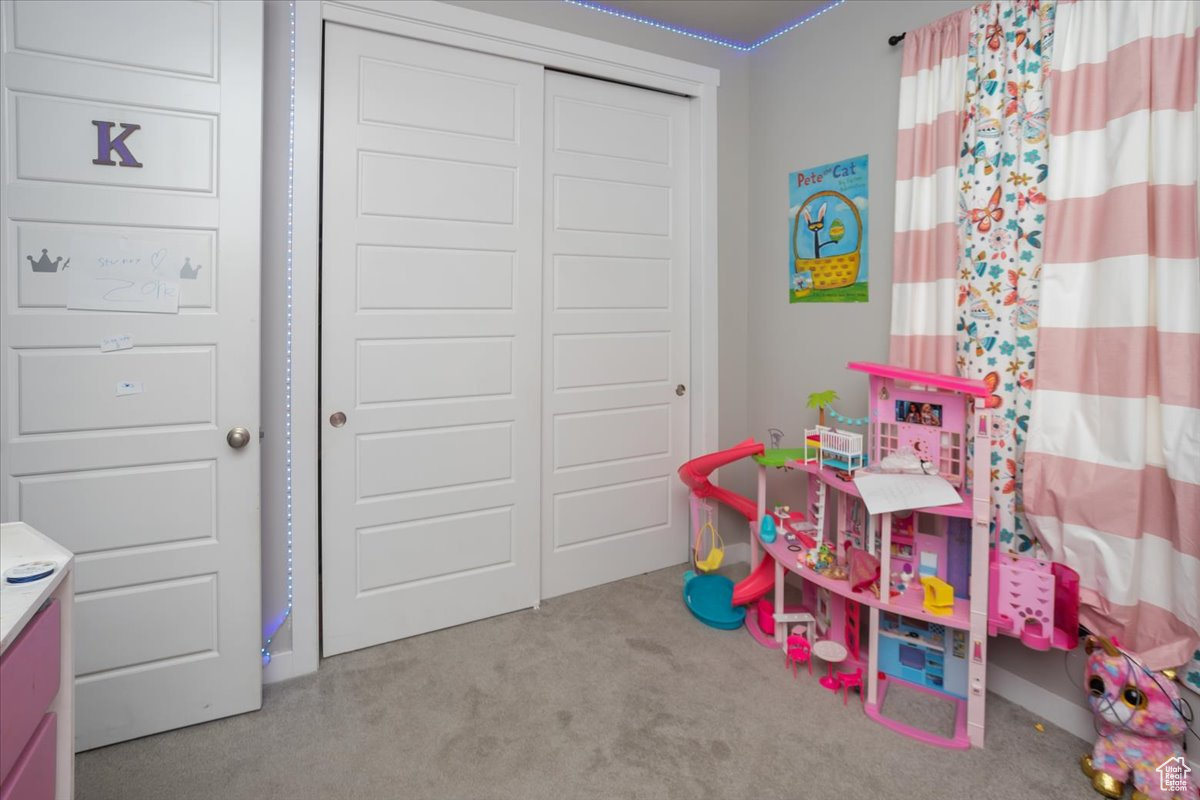 Recreation room featuring light colored carpet