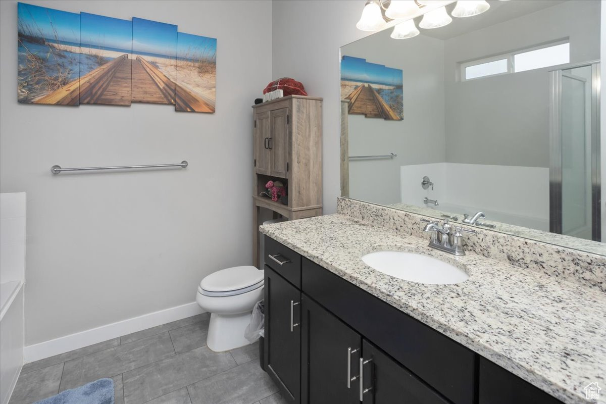 Full bathroom featuring tile patterned flooring, vanity, independent shower and bath, and toilet