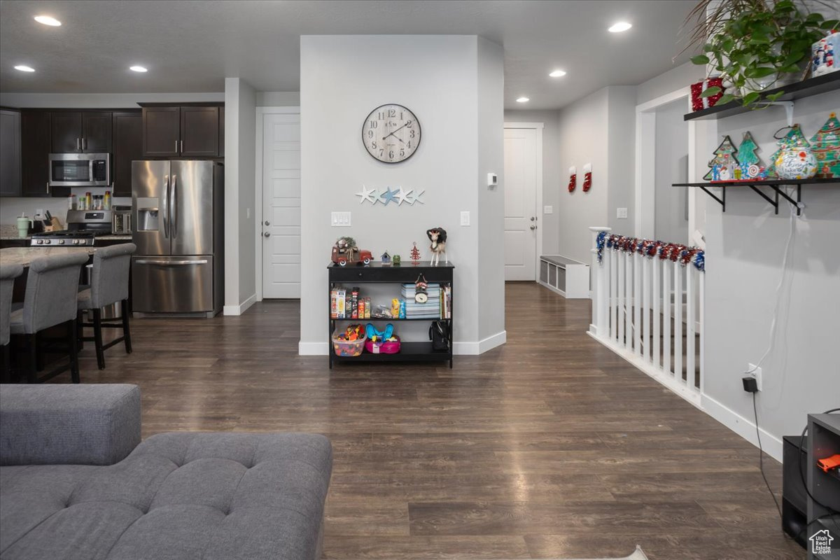 Living room with dark hardwood / wood-style flooring