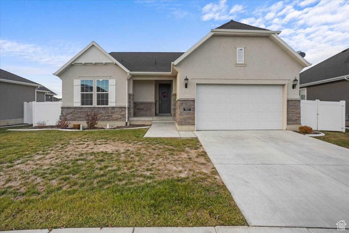 View of front facade with a garage and a front yard