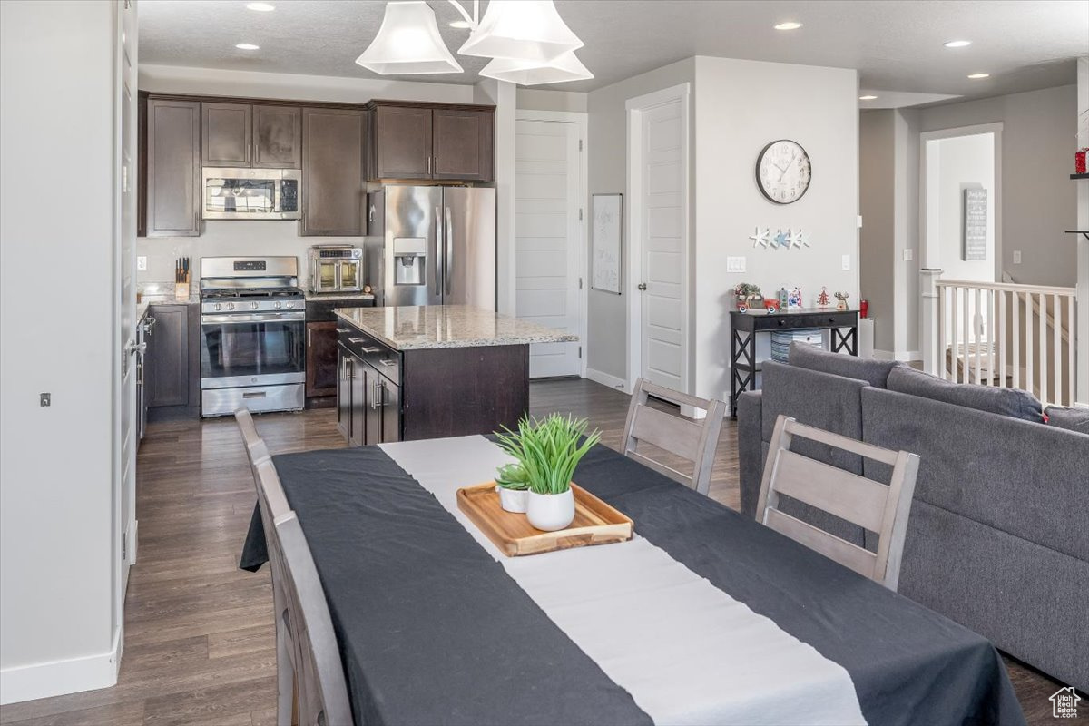 Dining area with dark wood-type flooring