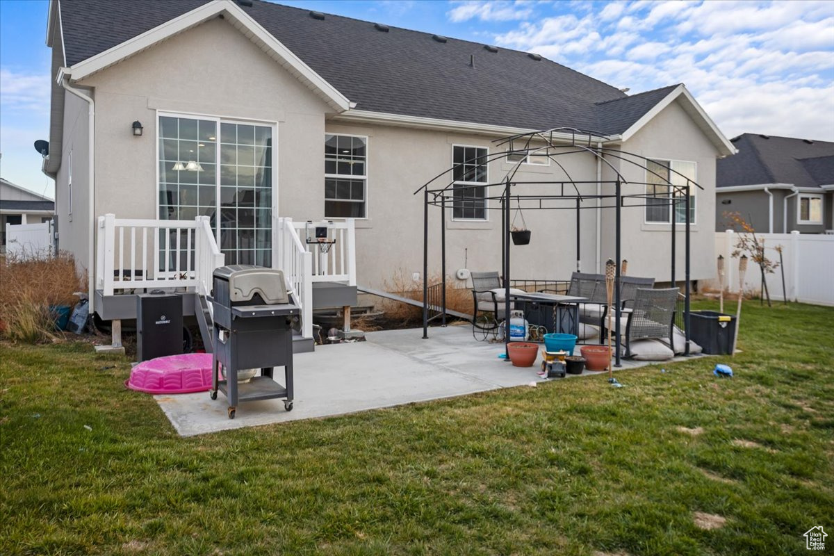 Back of property featuring a patio area and a yard