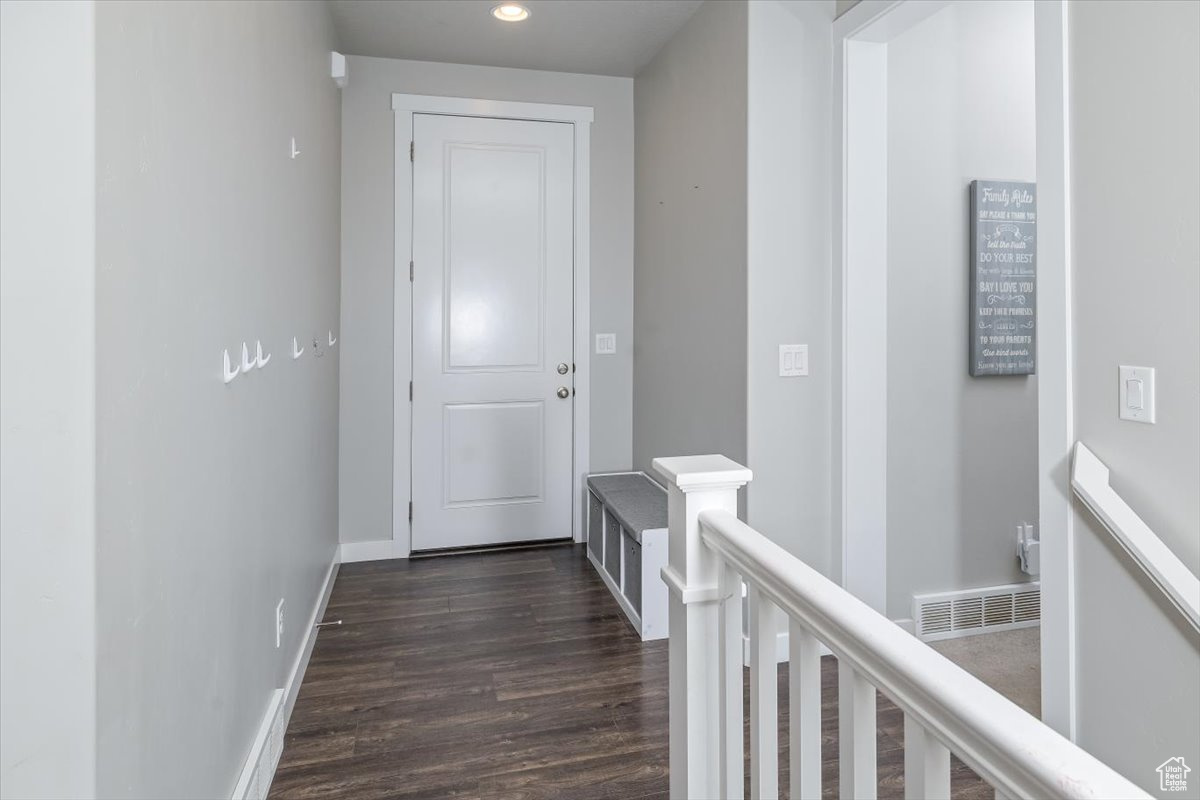 Hallway with dark hardwood / wood-style floors