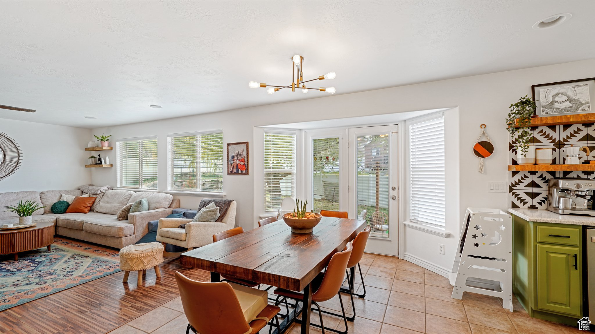 Tiled dining room with a chandelier