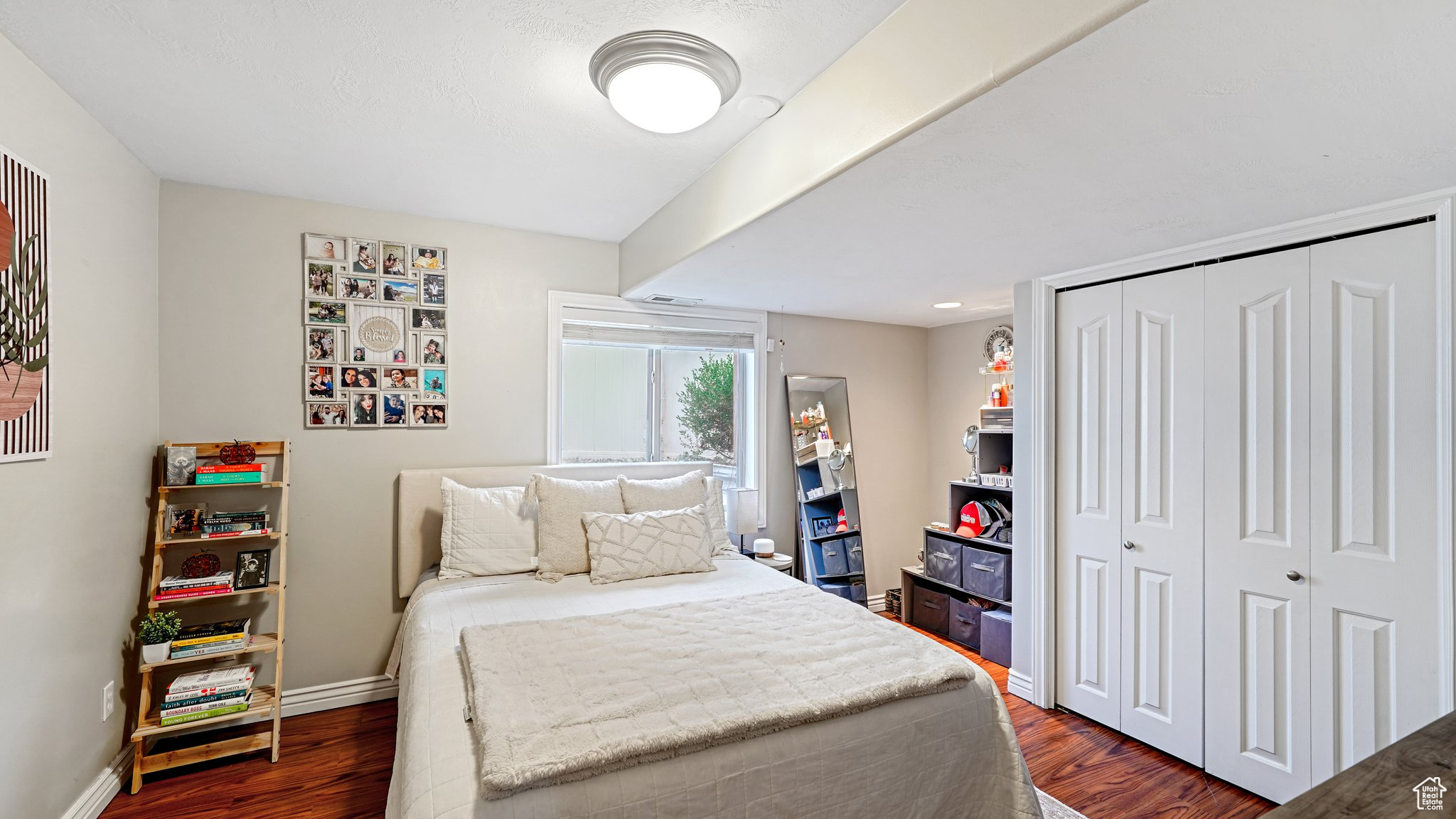 Bedroom featuring dark hardwood / wood-style flooring and a closet