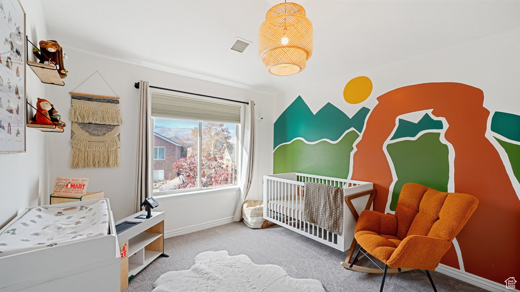 Bedroom featuring carpet floors and a nursery area