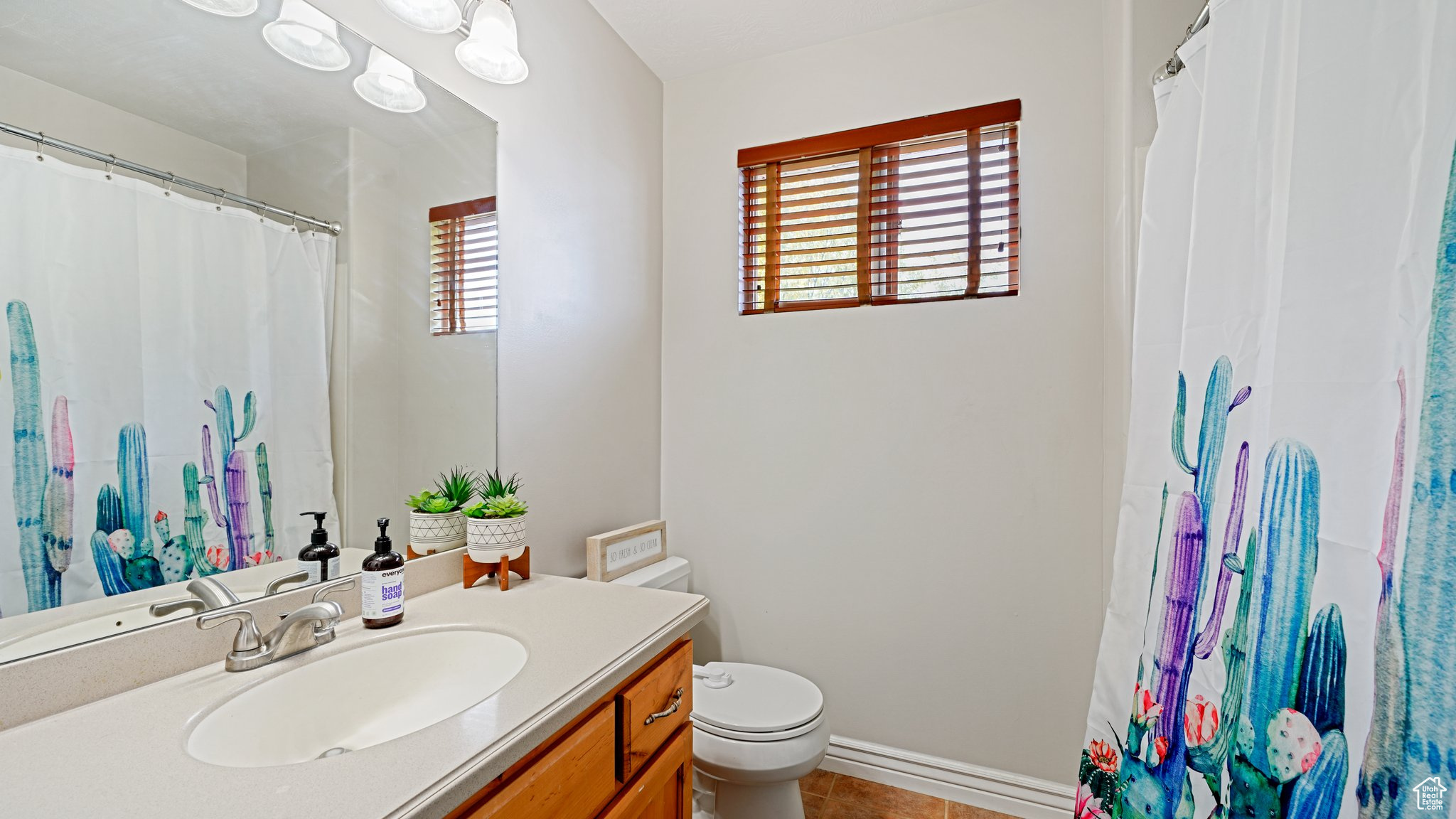 Bathroom featuring tile patterned flooring, vanity, and toilet