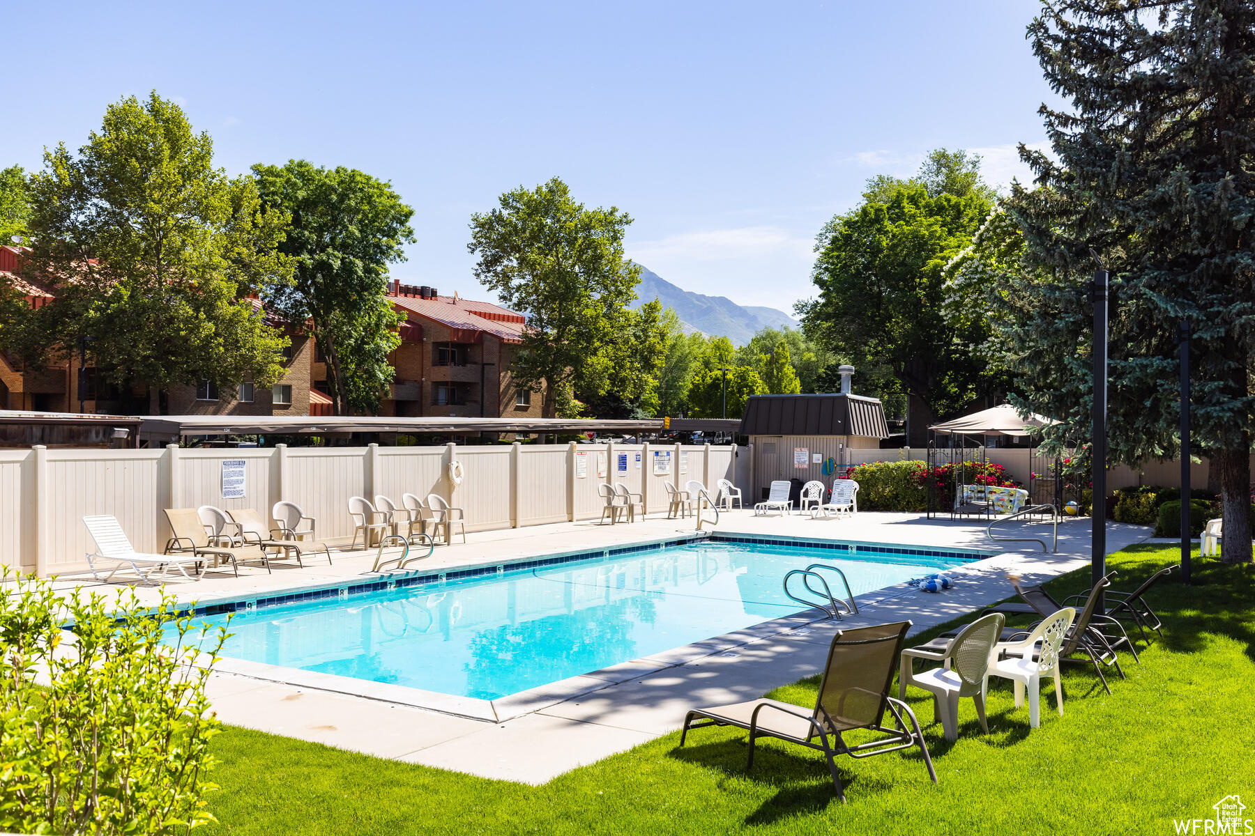 View of swimming pool with a mountain view and a yard