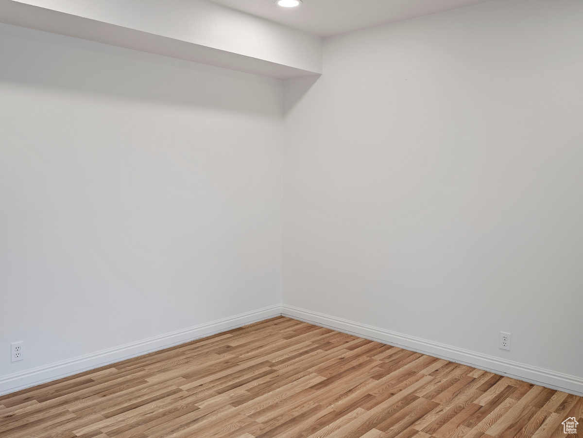 Empty room with light hardwood / wood-style floors