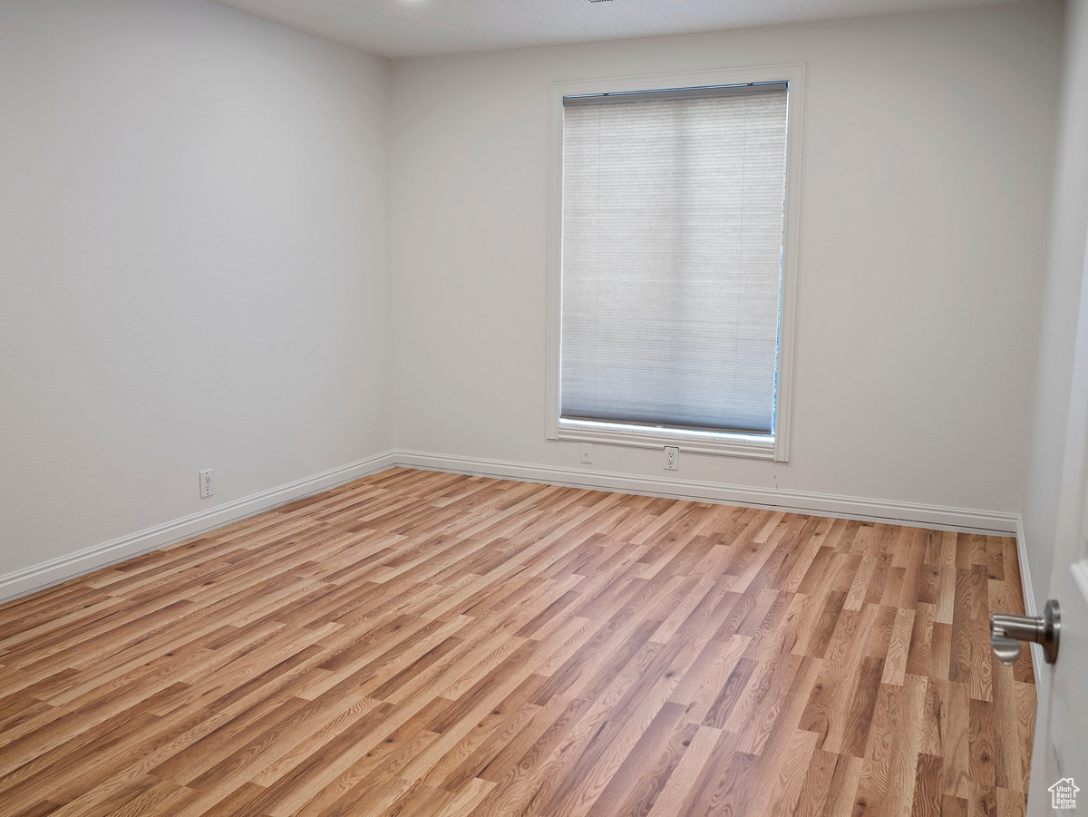 Empty room with light wood-type flooring