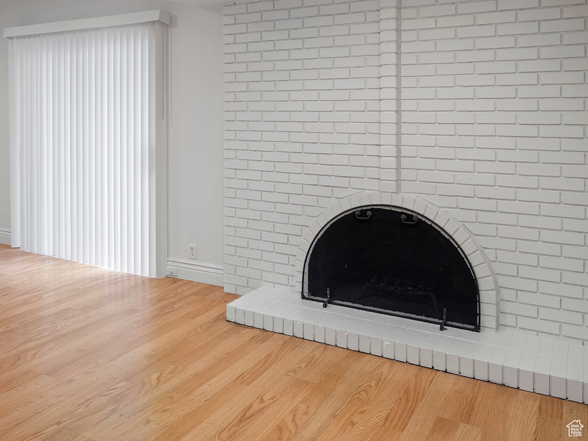 Room details featuring a fireplace and hardwood / wood-style floors