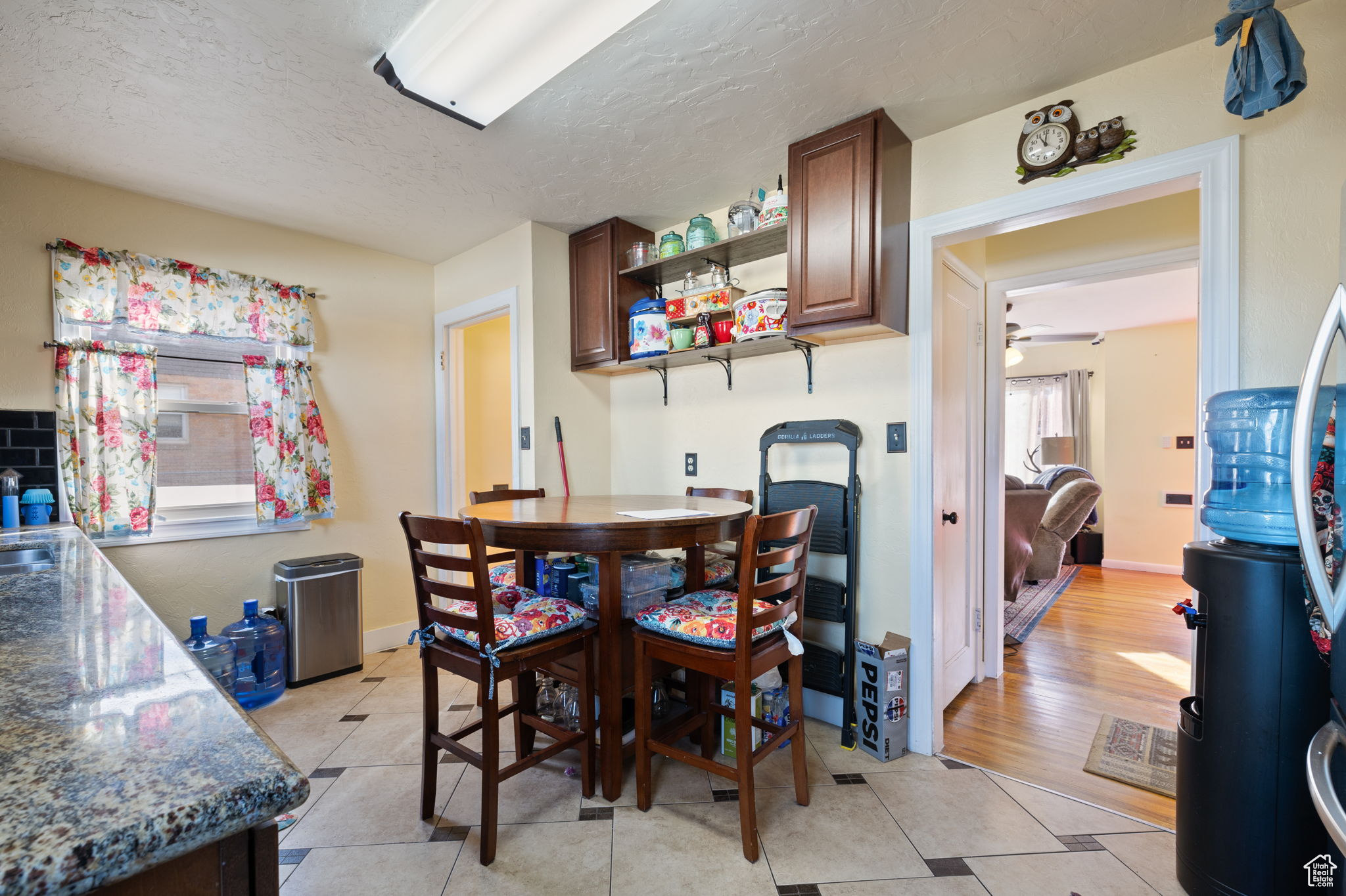 Dining room featuring a textured ceiling and light hardwood / wood-style floors