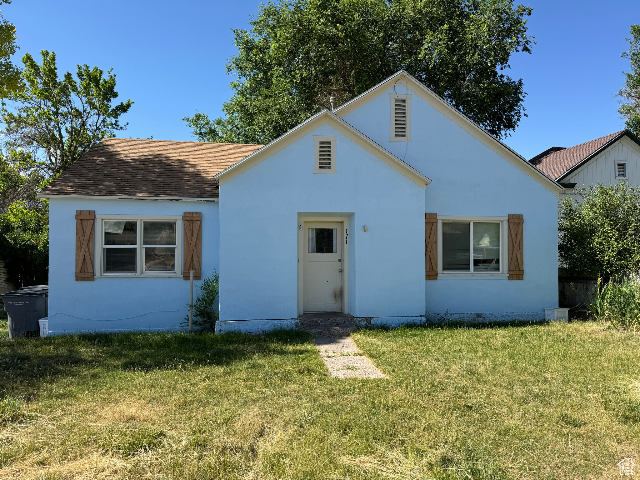 Rear view of house with a yard