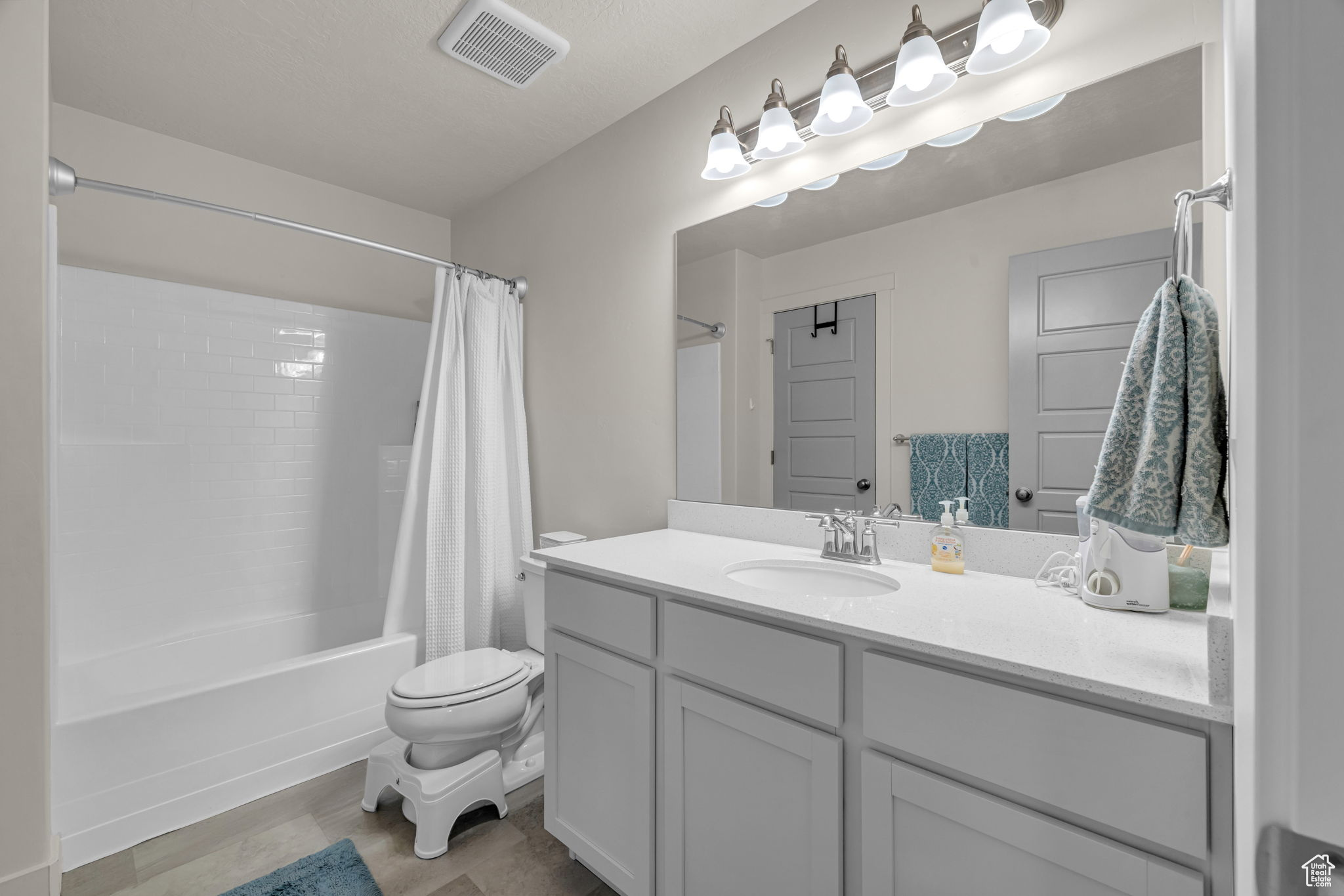 Full bathroom featuring vanity, toilet, and shower / bath combo with shower curtain