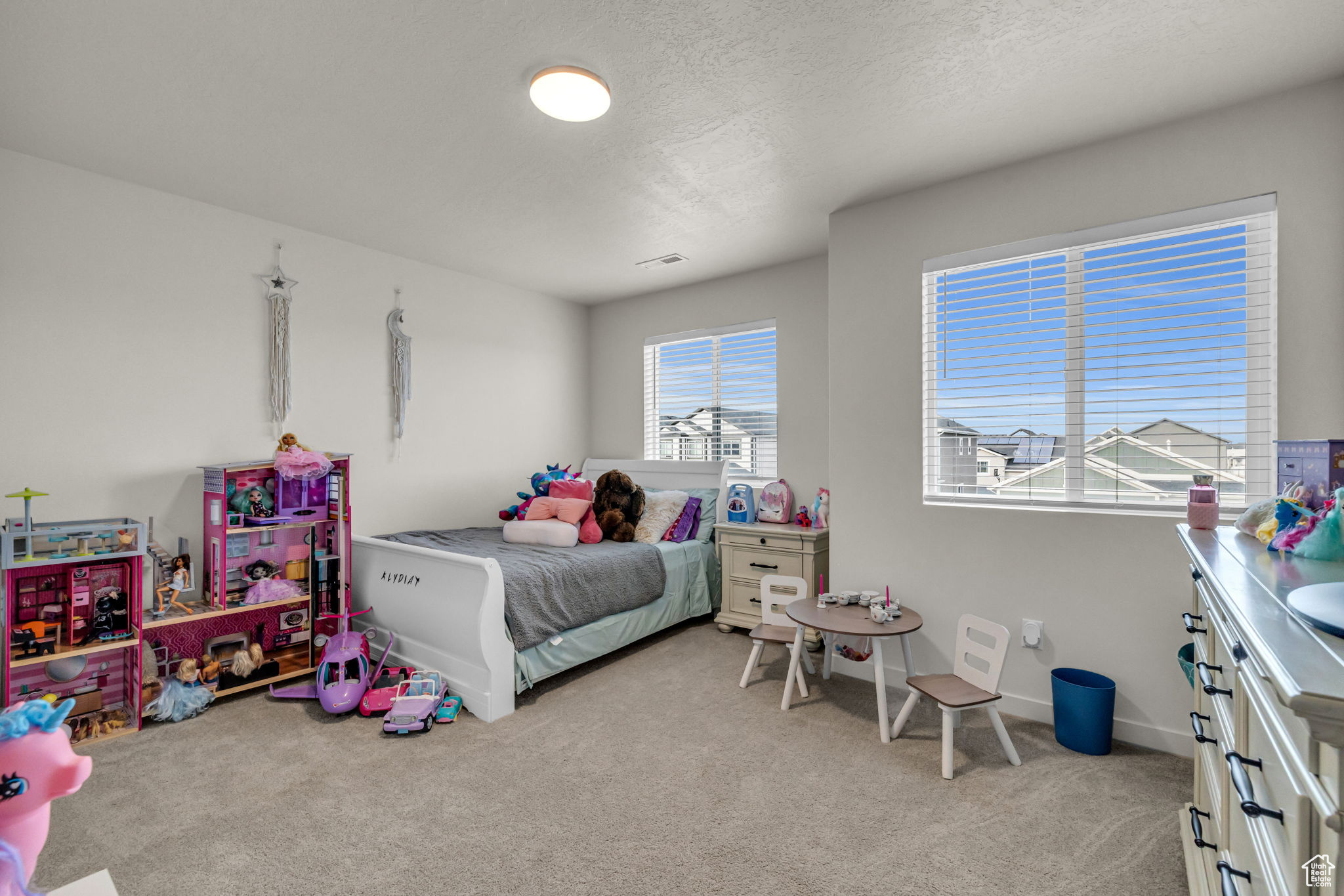 Bedroom featuring light colored carpet and a textured ceiling