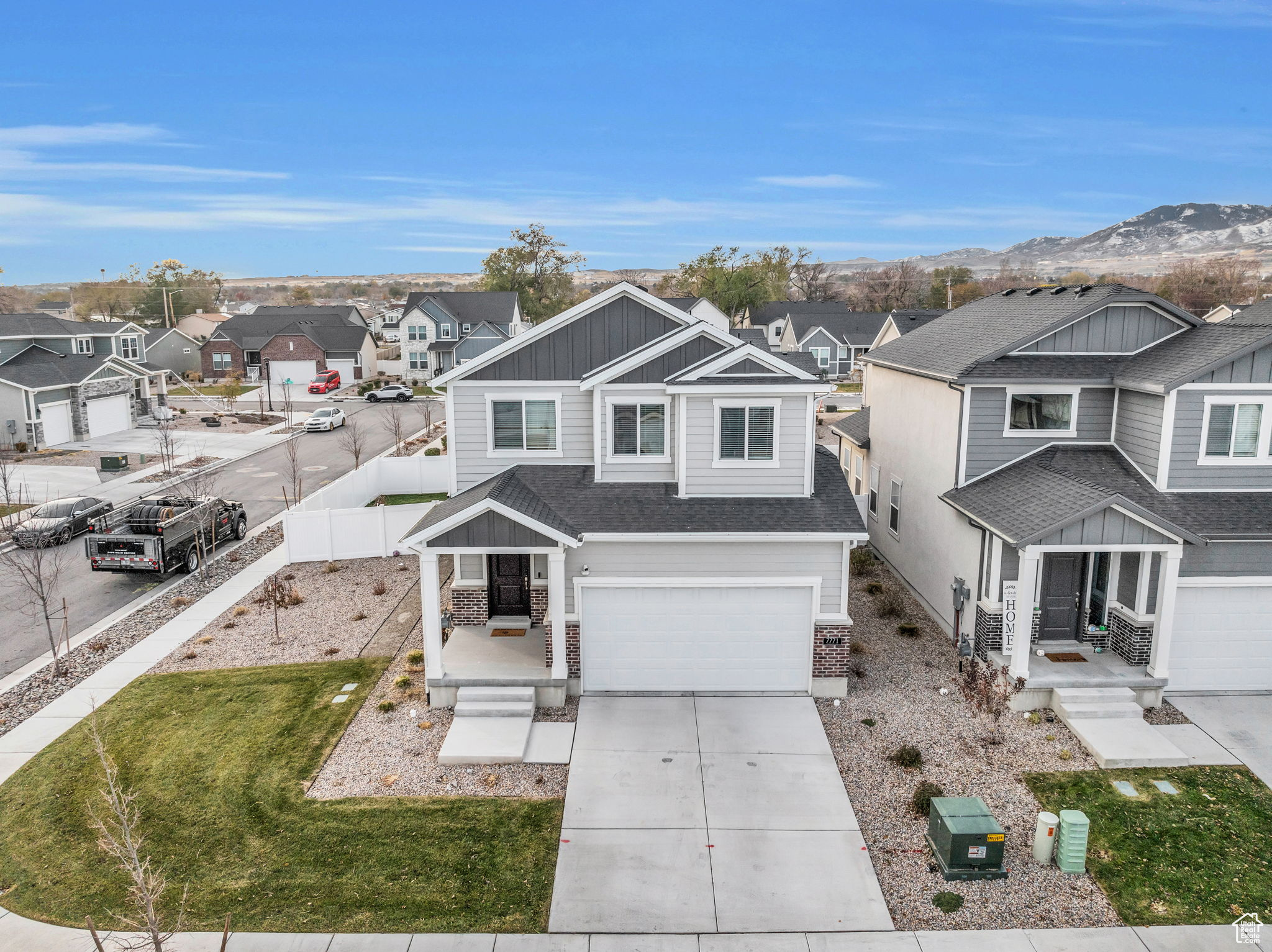 View of front facade featuring a mountain view, a garage, and a front yard