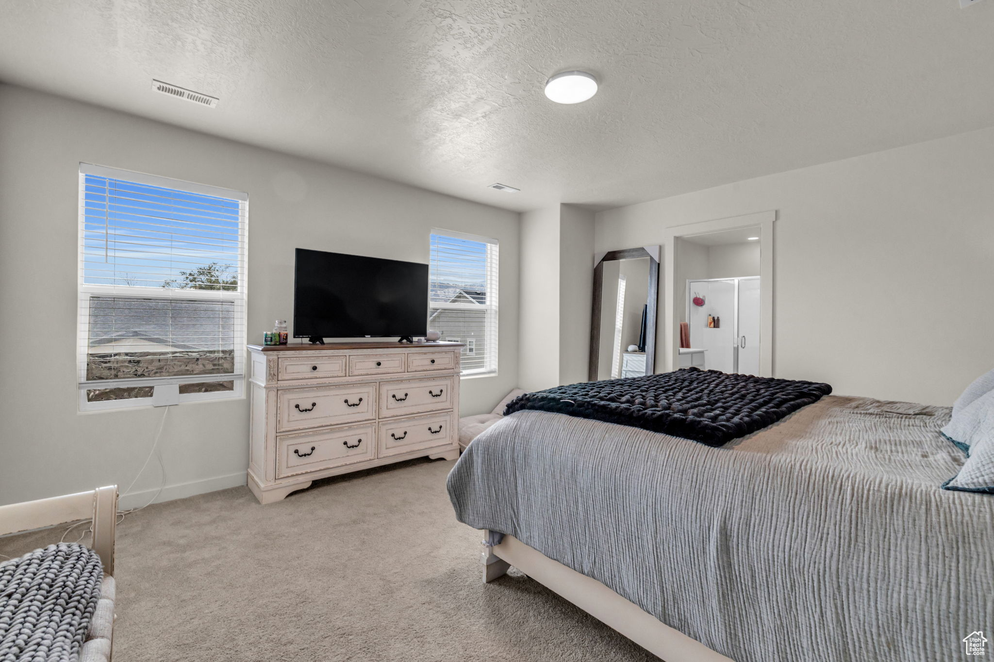 Carpeted bedroom featuring a textured ceiling