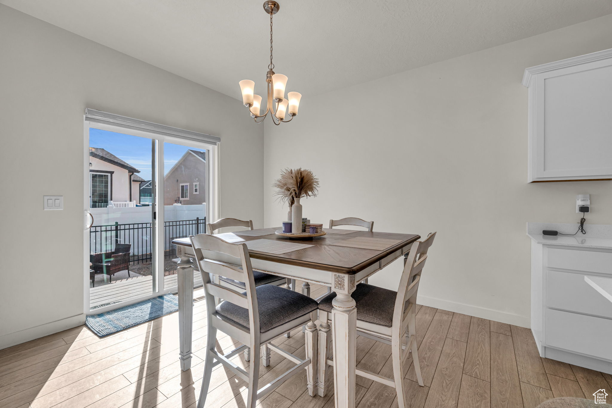 Dining area featuring light hardwood / wood-style floors and a notable chandelier