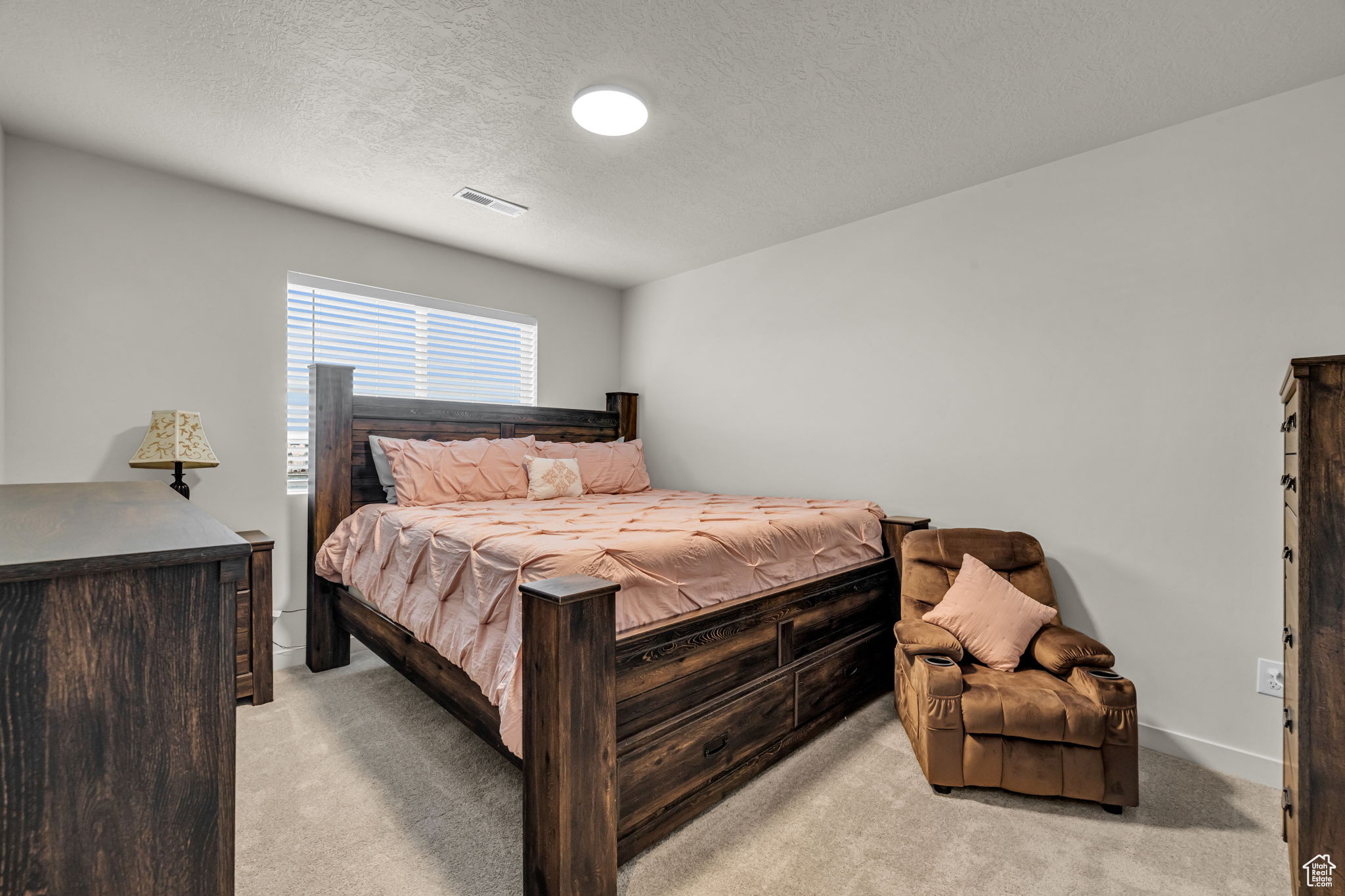 Carpeted bedroom featuring a textured ceiling