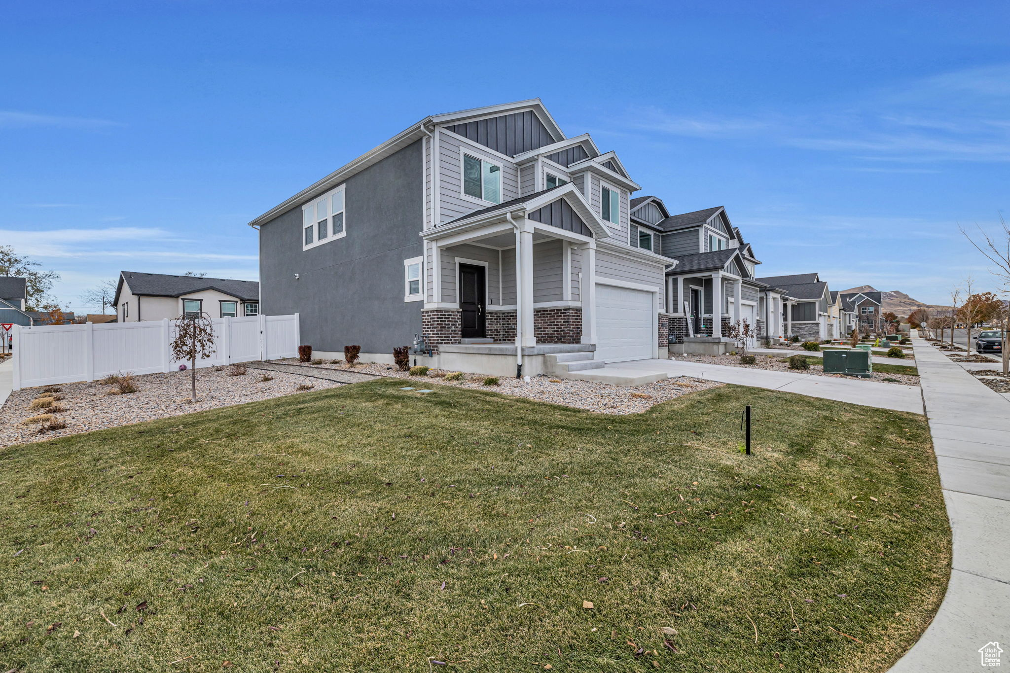 View of front of property with a front yard and a garage