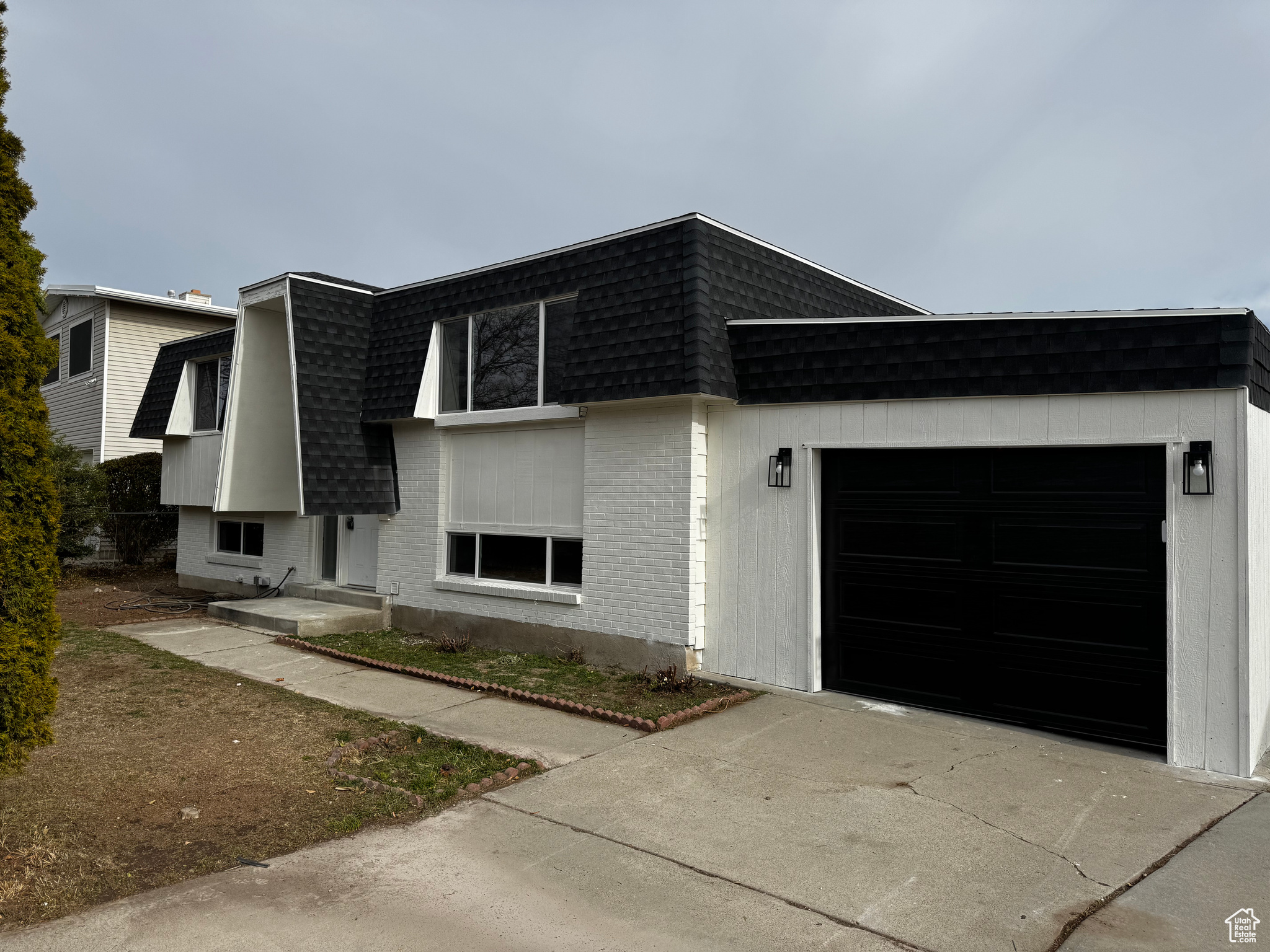 View of front facade featuring a garage