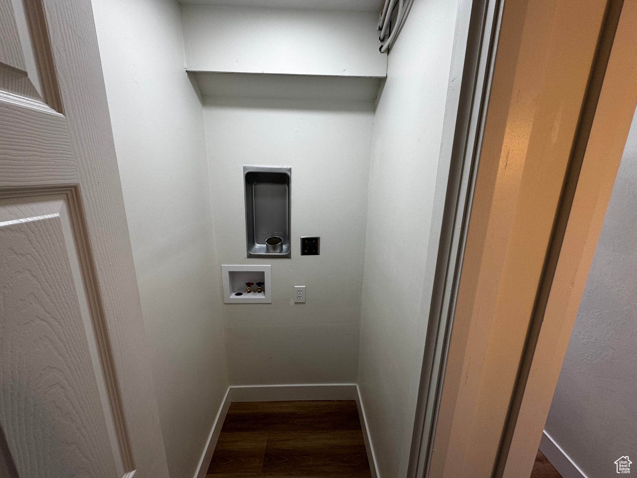 Laundry area with hookup for a washing machine and dark hardwood / wood-style floors